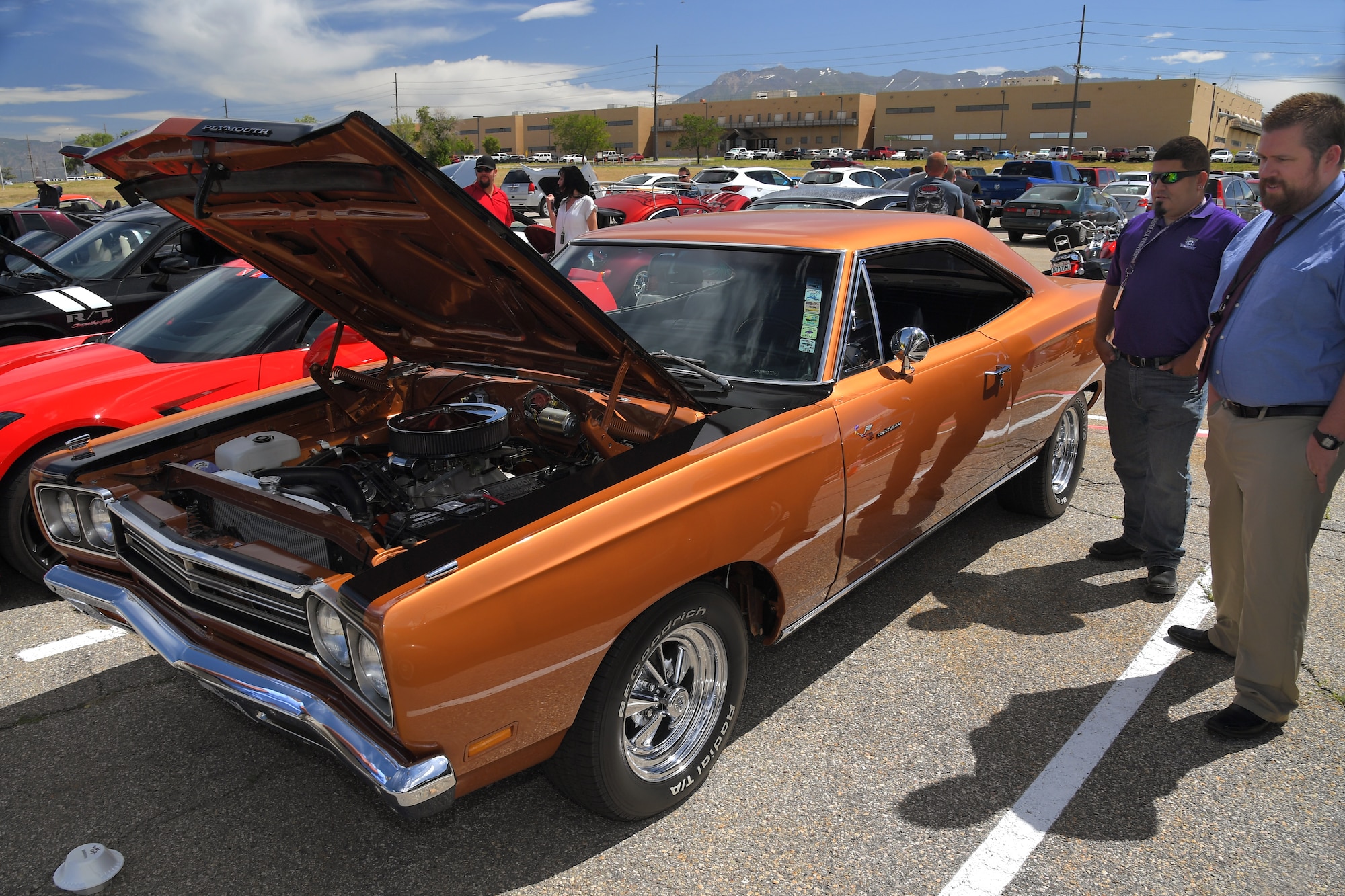 Guests enjoy a mix of modern and restored classics at a car show and barbecue hosted by base’s Foreign Military Sales organization at Hill Air Force Base, Utah, June 27, 2019. The event was a first for the unit, and several program teams and employees displayed and shared details with visitors about their personally owned vehicles. (U.S. Air Force photo by Todd Cromar)