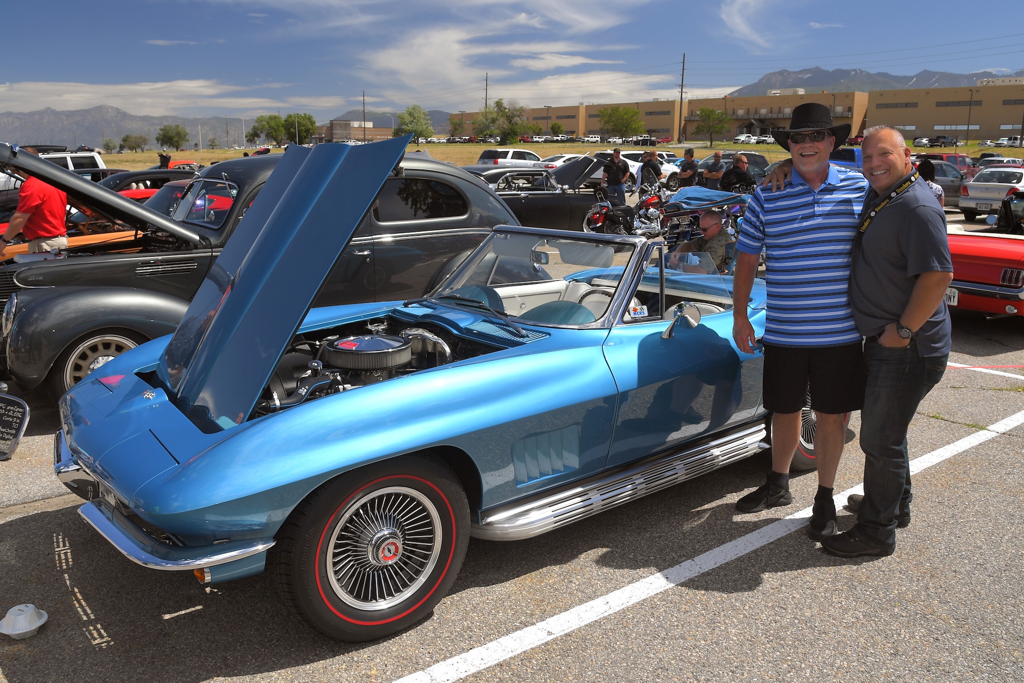 Jace Holt and Troy Cook, both with the F-16 System Program Office, pose with Holt’s original 1967 Corvette convertible at a car show and barbecue hosted by Foreign Military Sales at Hill Air Force Base, Utah, June 27, 2019. The event was a first for the unit, and several program teams and employees displayed and shared details with visitors about their personally owned vehicles. (U.S. Air Force photo by Todd Cromar)