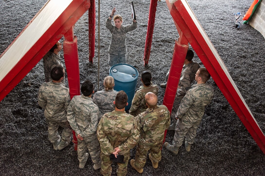 Officer Training School trainees participate in team building and leadership exercises at the OTS Leadership Reaction Course, June 26, 2019, Maxwell Air Force Base, Alabama. The course is comprised of a series of obstacles in which trainees have to work together to solve. (US Air Force photo by Melanie Rodgers Cox)