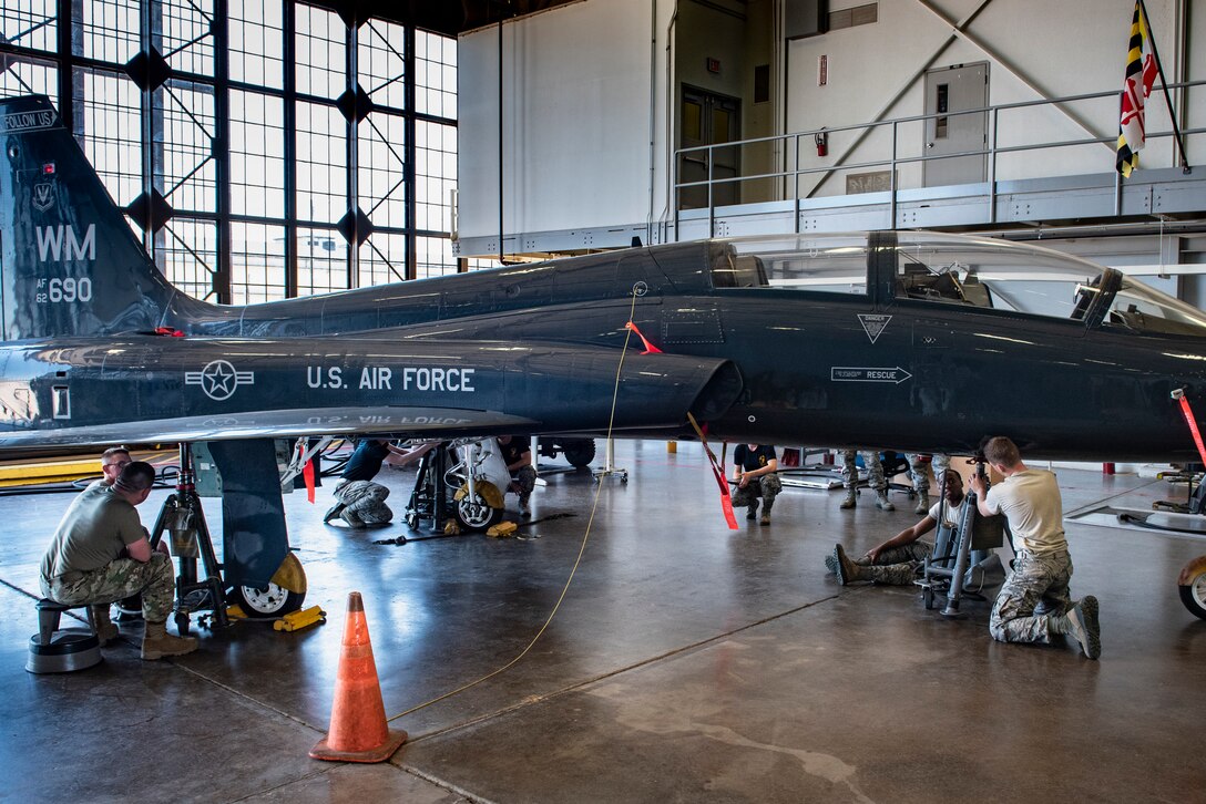 364th Training Squadron hydraulic systems apprentice course students use aircraft tripod jacks to lift up a T-38 Talon at Sheppard Air Force Base, Texas, June 28, 2019. Each tripod jack is requires two people and is manually operated. The students are lifting the jet to perform a gear swing operational check. (U.S. Air Force photo by Airman 1st Class Pedro Tenorio)