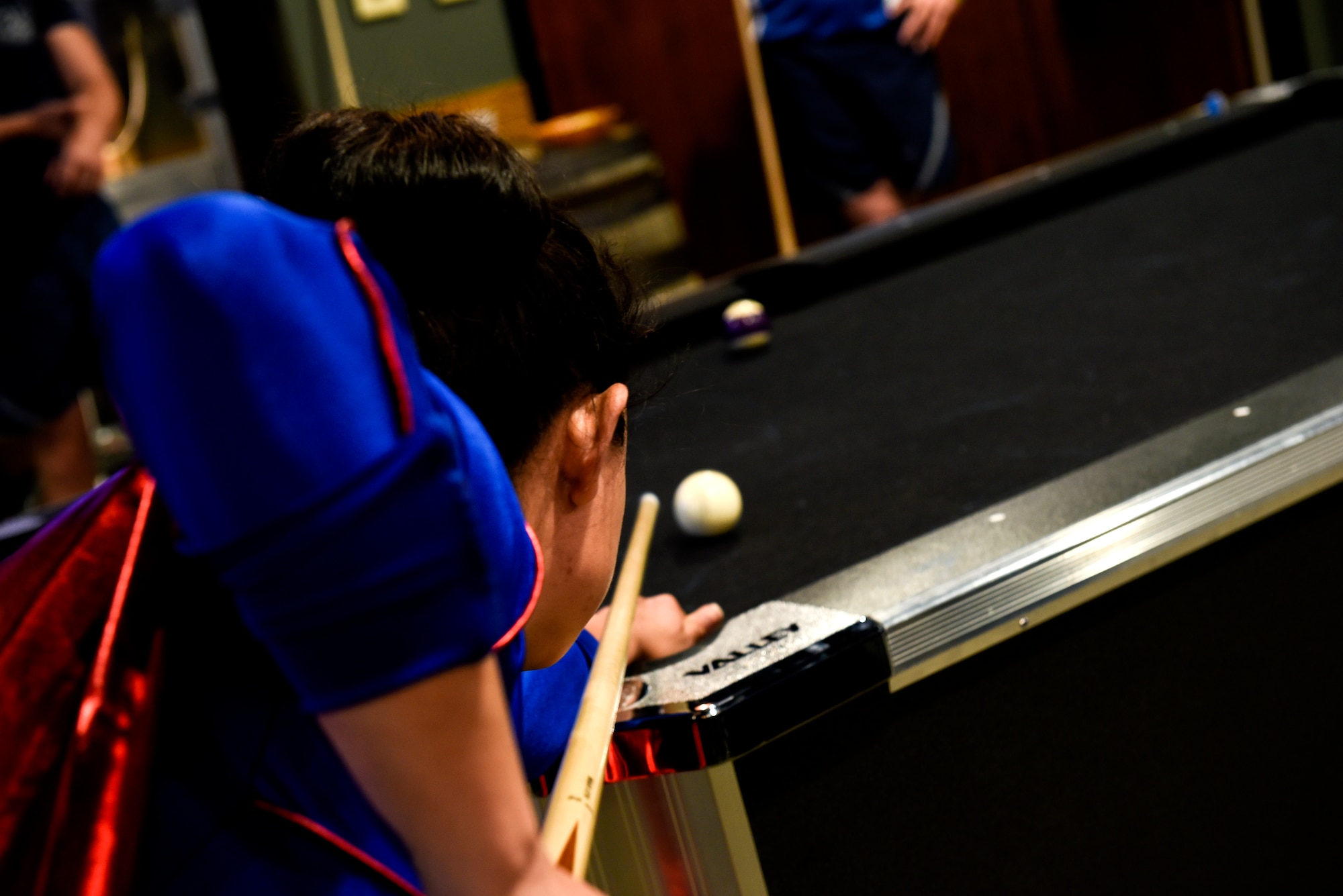 PETERSON AIR FORCE BASE, Colo.—Master Sgt. Jenny Robinson, 21st Space Wing executive assistant for the director of staff, takes a shot during the billiards finals at the 2019 Team Pete Sports and Field Day June 21, at Peterson Air Force Base, Colorado. The billiards finals took place at The Club and consisted of three rounds. (U.S. Air Force photo by Airman Alexis Christian)