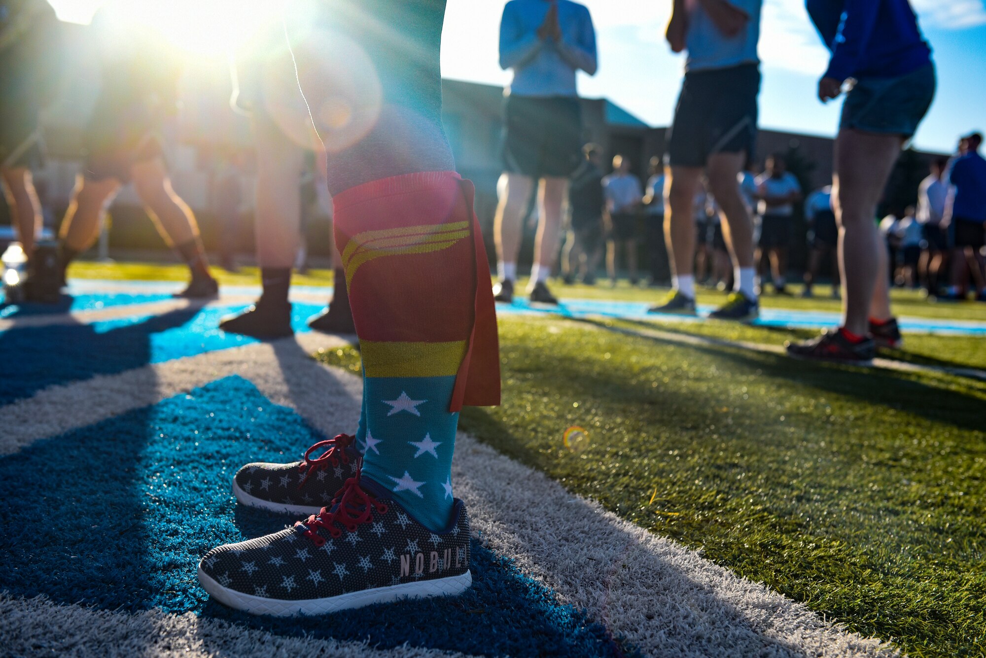 PETERSON AIR FORCE BASE, Colo.—Members of the 21st Space Wing gather on the football field at Peterson Air Force Base, Colorado, June 21, 2019 to prepare for a 5K run. The run kicked off the 2019 Team Pete Sports and Field Day, with many individuals showing up dressed to match the superhero theme. (U.S. Air Force photo by Airman Alexis Christian)