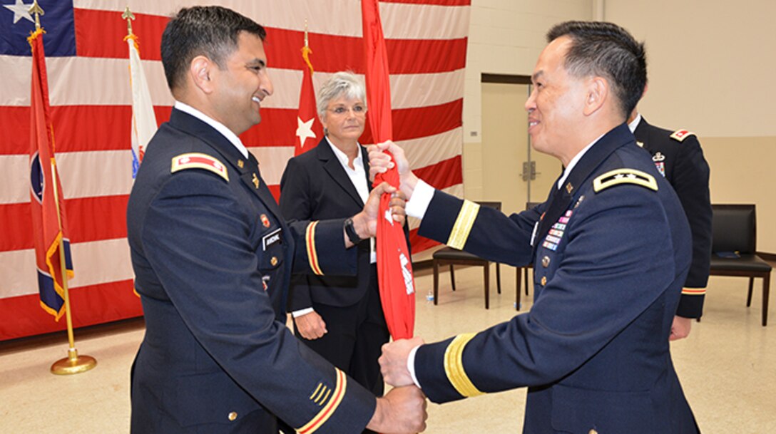 Maj. Gen. Mark Toy (Right), U.S. Army Corps of Engineers Great Lakes and Ohio River Division commander, passes the Corps of Engineers flag to Lt. Col. Sonny B. Avichal as he took command of the Nashville District during a change of command ceremony June 28, 2019 at the Tennessee National Guard Armory in Nashville, Tenn. (USACE photo by Mark Rankin)
