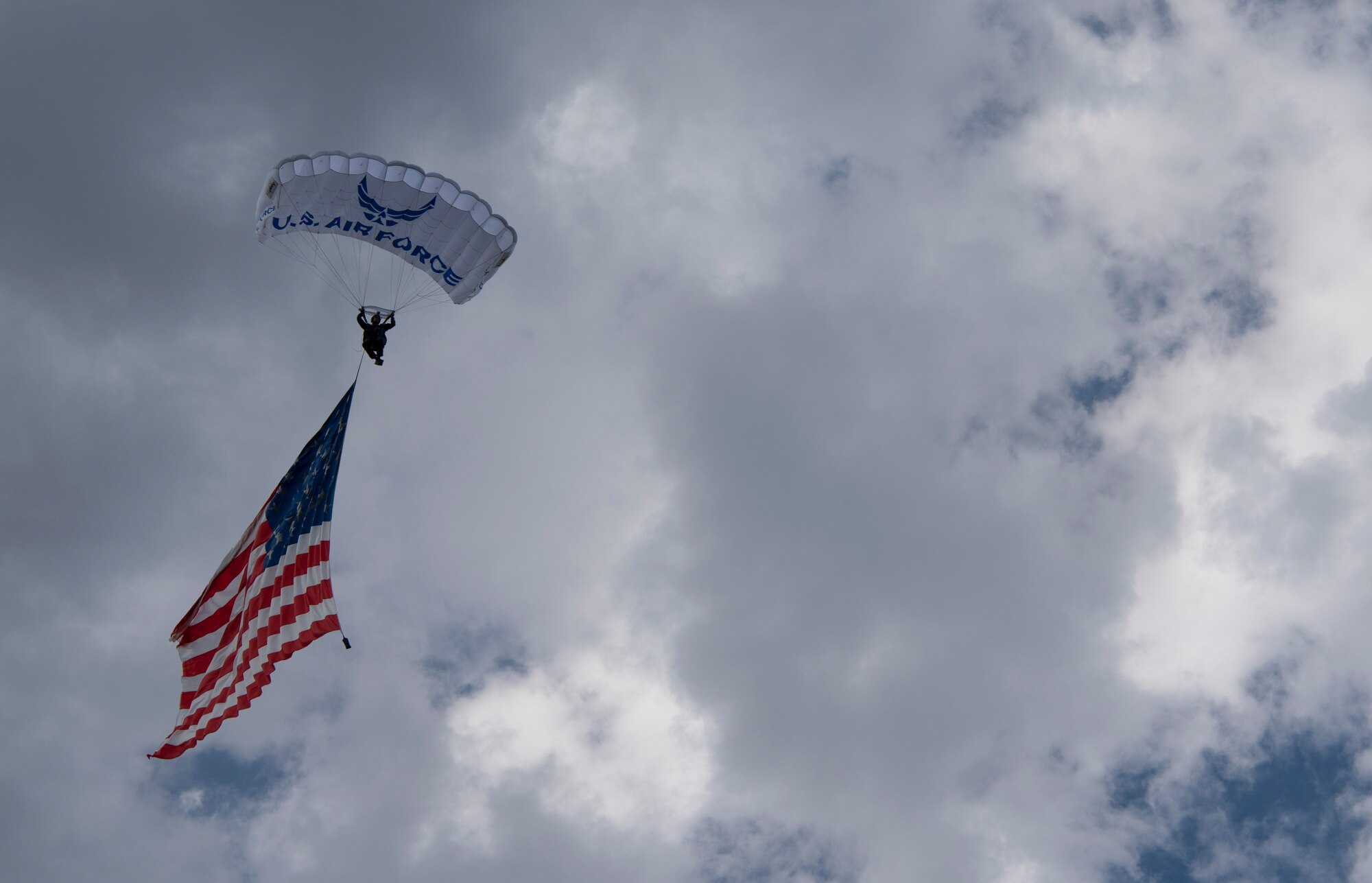 Lt. Col. Andrew Judkins, 70th Flying Training Squadron, parachutes with an American flag before a Rocky Mountain Vibes game in Colorado Springs, Colorado, June 27, 2019. The demonstration was part of Military Appreciation Night, where military personnel received free admission to the Vibes game. (U.S. Air Force photo by Airman 1st Class Jonathan Whitely)