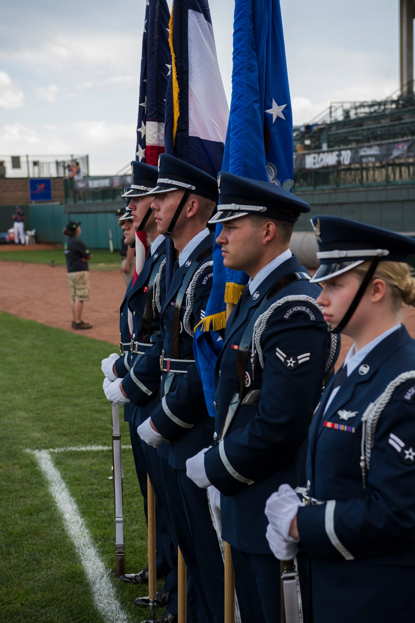 High Frontier Honor Guard members stand at ceremonial parade rest prior to posting the colors for the National Anthem at a Rocky Mountain Vibes game in Colorado Springs, Colorado, June 27, 2019. During Military Appreciation Night, military personnel were honored for their service to the United States. (U.S. Air Force photo by Airman 1st Class Jonathan Whitely)