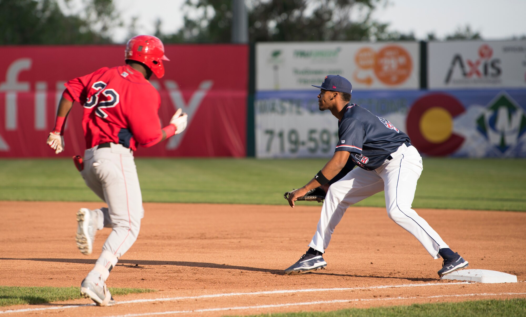 Rocky Mountain Vibes first baseman, Ernesto Martinez, right, anticipates a throw to tag out Orem Owlz outfielder, D’Shawn Knowles, left, during a Rocky Mountain Vibes game in Colorado Springs, Colorado, June 27, 2019.  The Vibes lost 3-1, dropping their overall record to 4-8 on the season. (U.S. Air Force photo by Airman 1st Class Jonathan Whitely)