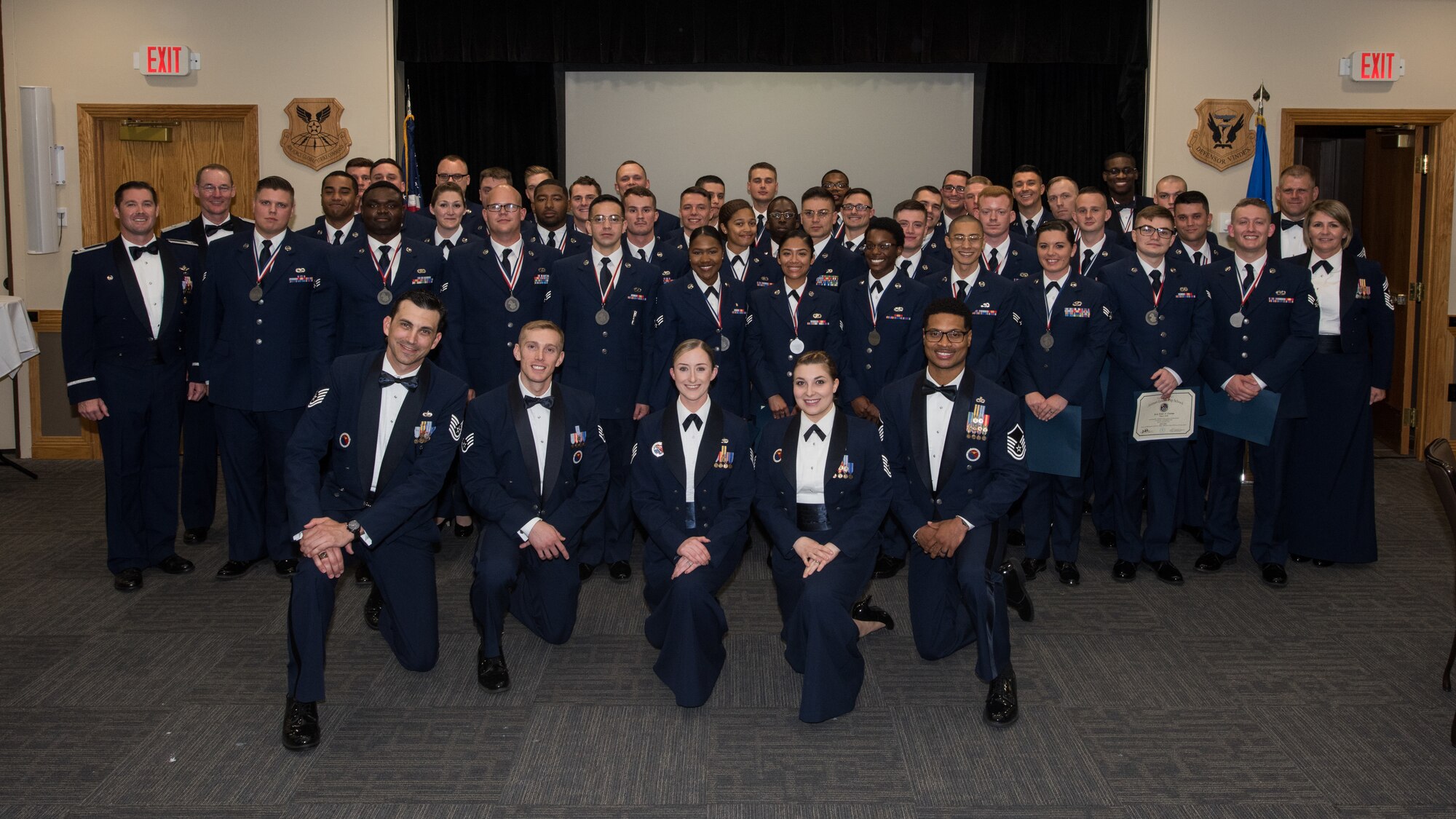 The Whiteman Airman Leadership School Class 19-E gathers after their graduation ceremony at Whiteman Air Force Base, Missouri, June 27, 2019. Thier class motto was: "What we do in life, echoes into eternity." The nearly six-week course provides students with tools to effectively lead Airmen. (U.S. Air Force photo by Staff Sgt. Danielle Quilla)