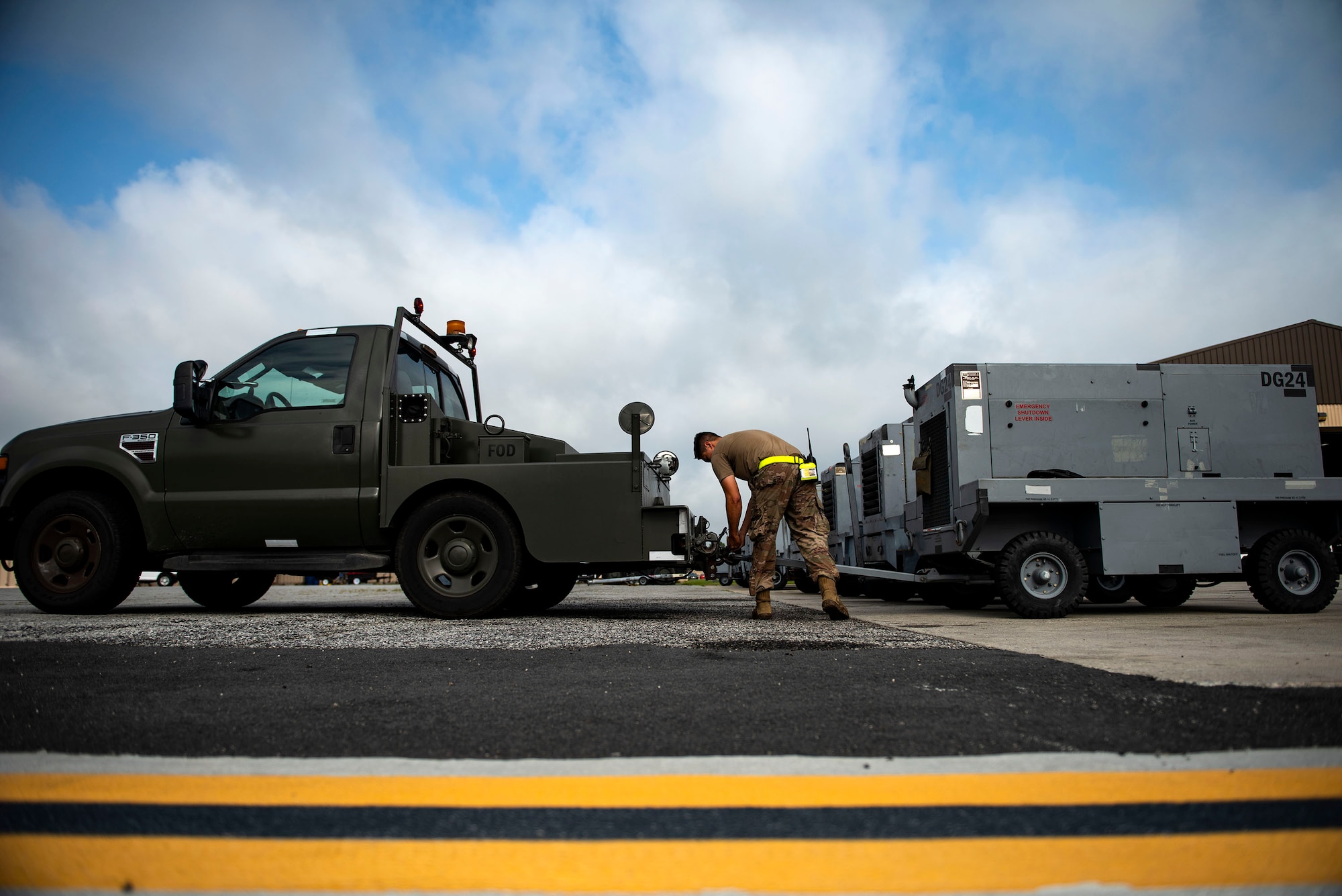 Senior Airman Brennan Hawk, 23d Maintenance Squadron aerospace ground equipment (AGE) journeyman, unhooks a generator during a dispatch, June 21, 2019, at Moody Air Force Base, Ga. AGE maintains the equipment needed to repair the three airframes in the 23d Wing. To accomplish this, AGE is broken down into three main functions: inspections, maintenance and dispatch. The dispatch section supports the movement of approximately 500 pieces of equipment, from hydraulic-test stands to generators and from axel jacks to air conditioners. AGE accumulates more than 1,300 hours of dispatches per month. (U.S. Air Force photo by Senior Airman Erick Requadt)