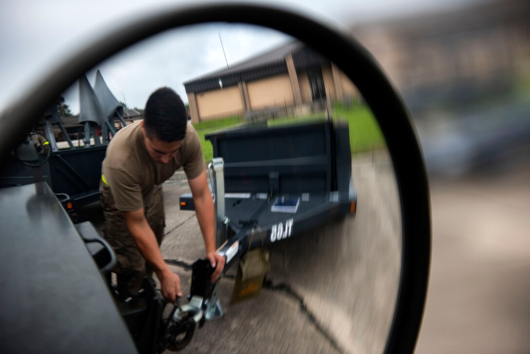 Senior Airman Brennan Hawk, 23d Maintenance Squadron aerospace ground equipment (AGE) journeyman, unhooks a trailer during a dispatch, June 21, 2019, at Moody Air Force Base, Ga.  AGE maintains the equipment needed to repair the three airframes in the 23d Wing. To accomplish this, AGE is broken down into three main functions: inspections, maintenance and dispatch. The dispatch section supports the movement of approximately 500 pieces of equipment, from hydraulic-test stands to generators and from axel jacks to air conditioners. AGE accumulates more than 1,300 hours of dispatches per month. (U.S. Air Force photo by Senior Airman Erick Requadt)