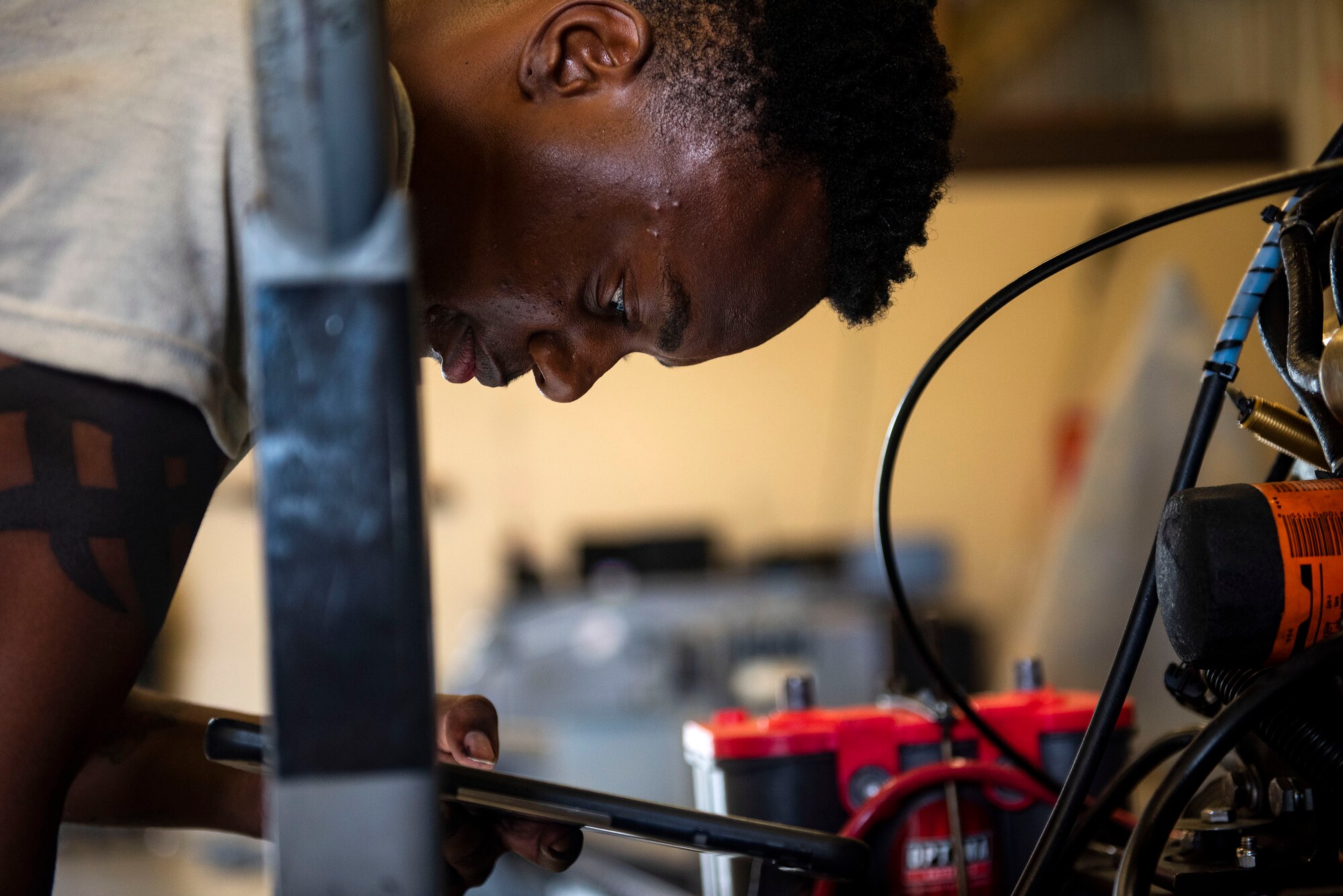Airman 1st Class Davon Frazier, 23d Maintenance Squadron aerospace ground equipment (AGE) journeyman, examines technical orders while repairing a self-generating nitrogen servicing cart, June 21, 2019, at Moody Air Force Base, Ga. AGE maintains the equipment needed to repair the three airframes in the 23d Wing. To accomplish this, AGE is broken down into three main functions: inspections, maintenance and dispatch. The maintenance section troubleshoots and repairs the equipment the dispatch section can’t readily fix out on the flightline. The maintenance section averages approximately 800 jobs a month. (U.S. Air Force photo by Senior Airman Erick Requadt)