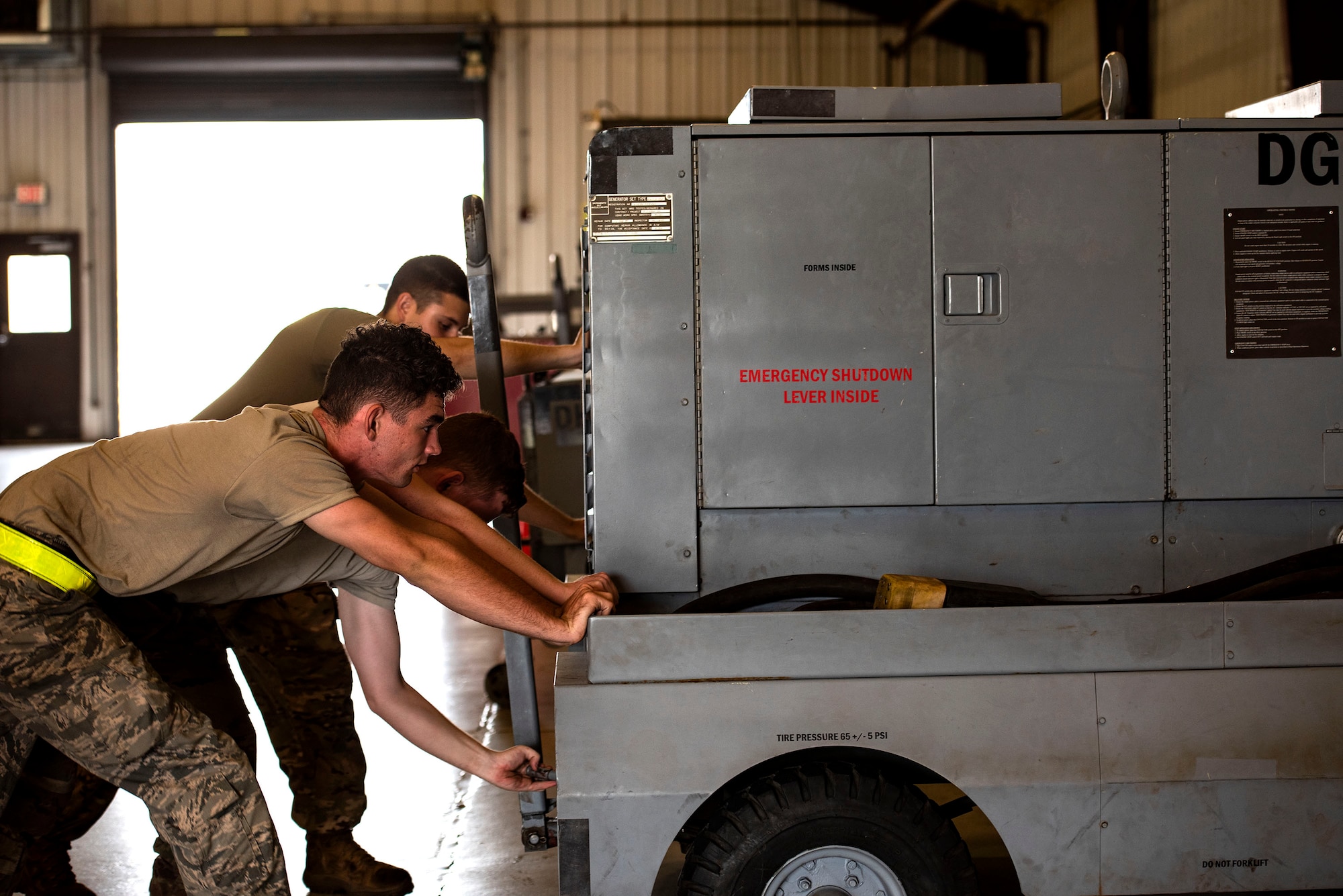 Aerospace ground equipment (AGE) Airmen from the 23d Maintenance Squadron push a generator, June 21, 2019, at Moody Air Force Base, Ga. AGE maintains the equipment needed to repair the three airframes in the 23d Wing. To accomplish this, AGE is broken down into three main functions: inspections, maintenance and dispatch. (U.S. Air Force photo by Senior Airman Erick Requadt)