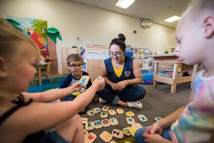 Stephanie Salazar, 502nd Force Support Squadron, child development program assistant, plays with kids, June 11, 2019, at the Gateway Child Development Center, Joint Base San Antonio-Lackland, Texas.