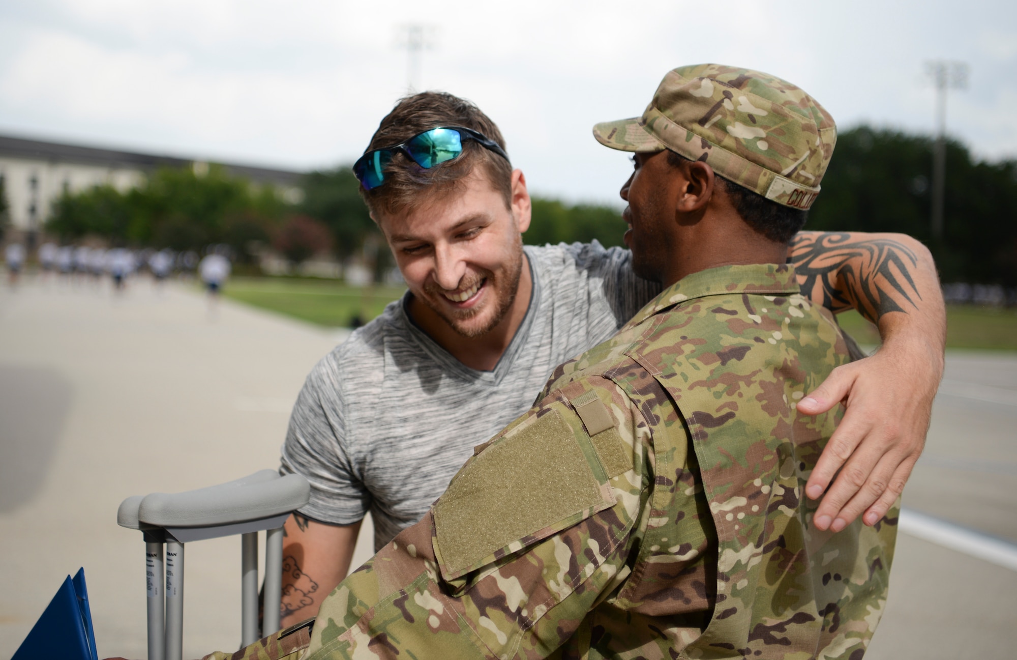 Dennis Boney, Harrison County Police Department deputy, hugs U.S. Air Force Tech. Sgt. Jonathan Collett, 336th Training Squadron cyber surety student, outside the Levitow Training Support Facillity on Keesler Air Force Base, Mississippi, June 27, 2019. A ceremony was held for Collett due to his heroic actions after rescuing Boney. (U.S Air Force photo by Airman 1st Class Spencer Tobler)