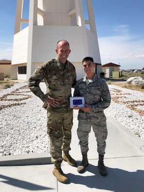 Brig. Gen. E. John Teichert, 412th Test Wing Commanding General, poses for a photo with Senior Airman Oscar Cantu, an Air Traffic Controller with 412th Operations Support Squadron. Cantu was given the Grit Award for overcoming challenges in pushing his innovative idea. (U.S. Air Force photo by Carlie Mensen)