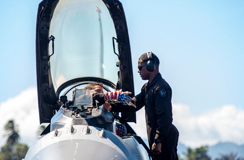 U.S. Air Force Capt. Jake “Primo” Impellizzeri, the Pacific Air Forces’ F-16 Demonstration Team commander, shakes hands with Staff Sgt. Andrew Newsome, a PACAF F-16 Demonstration Team crew chief, prior to take-off during the Cope West 19 open house at Sam Ratulangi International Airport, Manado, Indonesia June 22, 2019. The team’s primary mission is to showcase the F-16’s capabilities across the Pacific region however, the local community relations built during air shows are paramount. (U.S. Air Force photo by Staff Sgt. Melanie A Hutto)