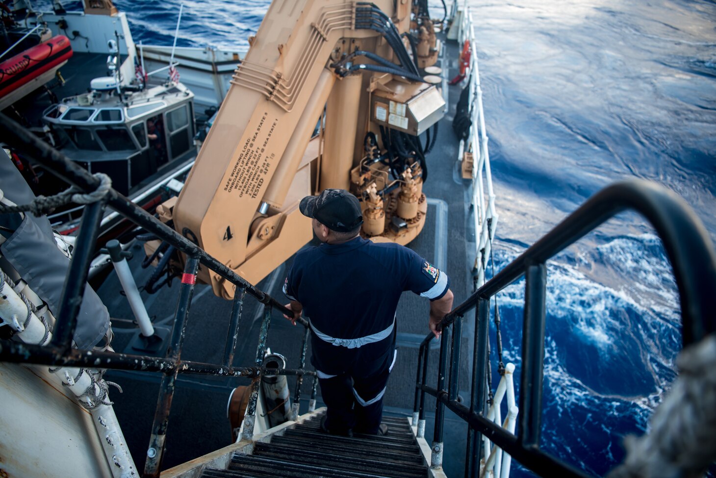 Josaia Maiwai, a Fijian fisheries officer, climbs down a ladder to get to the fantail of Coast Guard Cutter Stratton (WMSL 750) in the Western Pacific Ocean, June 25, 2019. Maiwai and the crew of the Stratton conducted joint patrols of United States and Fijian Exclusive Economic Zones while exercising the bilateral ship rider agreement that was signed in November 2018.