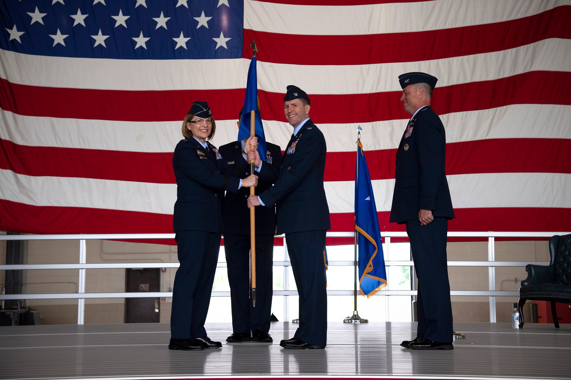 Col. Cameron Pringle, 319th Air Base Wing commander, assumes command in recieving the 319 ABW guidon from Maj. Gen. Mary O’Brian, 25th Air Force commander, during a change of command ceremony for the wing June 28, 2019, on Grand Forks Air Force Base, North Dakota.