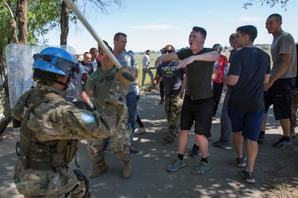Spc. Chanson Hardy, Utah Army National Guard, (hands raised) shouts at a Tajikistani soldier during public order training as part of Exercise Steppe Eagle 19 at Chilikemer Training Area near Almaty, Kazakhstan, June 25, 2019. Kazakhstan, the United States, the United Kingdom, Tajikistan, and Kyrgyzstan all sent participants for the exercise, while India, Turkey, and Uzbekistan sent observers. Steppe Eagle 19 is an annual U.S. Army Central-led exercise that promotes regional stability and interoperability in the Central and South Asia region.