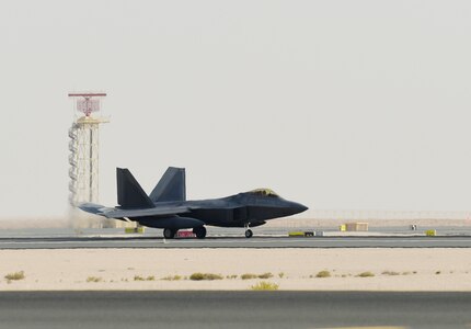 A photo of an F-22 taxiing down a runway.