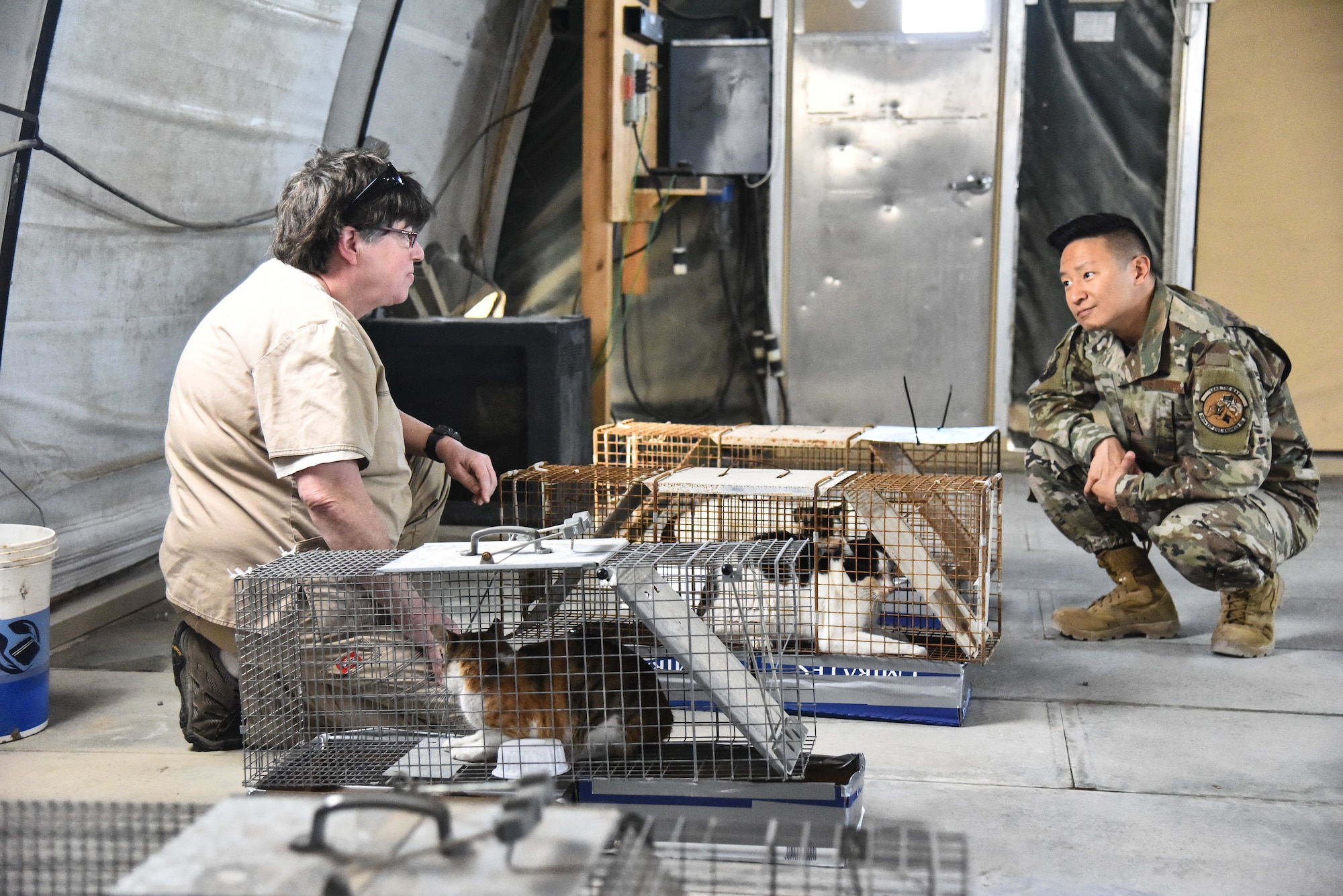 Tech. Sgt. Terence Park, 380th Expeditionary Civil Engineer Squadron pest management journeyman, speaks to Christie Heiser, Area Support Group Kuwait Camp Arifjan clinic manager, at Al Dhafra Air Base, United Arab Emirates, Feb. 18, 2019. Pest management Airmen have multiple capabilities ranging from keeping bases free of pests that could carry debilitating infectious diseases to repelling birds from airfields to ensure safe takeoff and landings, protecting the health and safety of everyone on base. (U.S. Air Force photo by Senior Airman Mya M. Crosby)