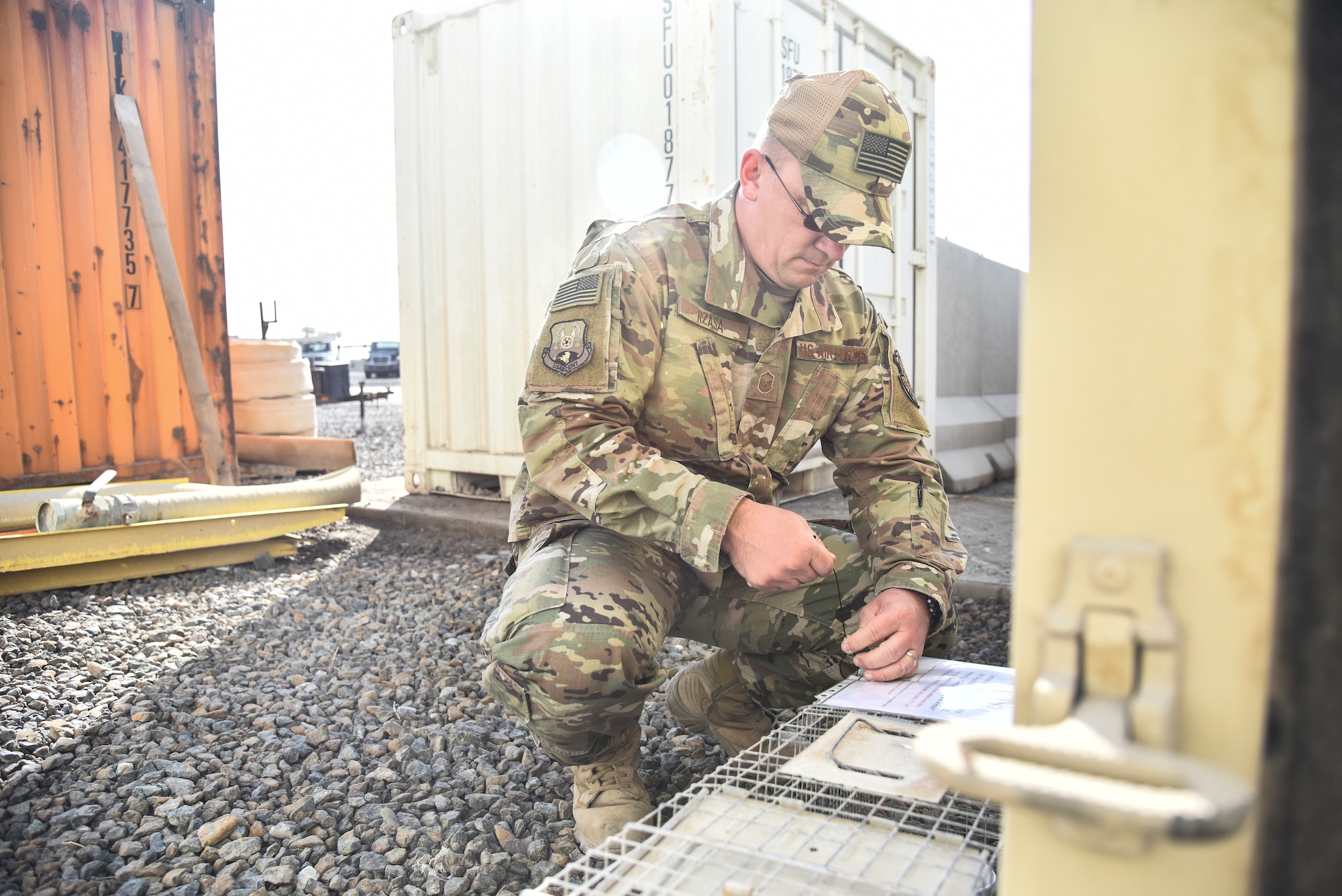 Master Sgt. Robert Rzasa, 380th Expeditionary Civil Engineer Squadron NCO in charge of pest management, labels a trap at Al Dhafra Air Base, United Arab Emirates, Feb. 18, 2019. Through the power of team work, the Airmen and Soldiers from ADAB and Camp Arifjan, came together to benefit the quality of life for all service members, and even the wild animals. (U.S. Air Force photo by Senior Airman Mya M. Crosby)