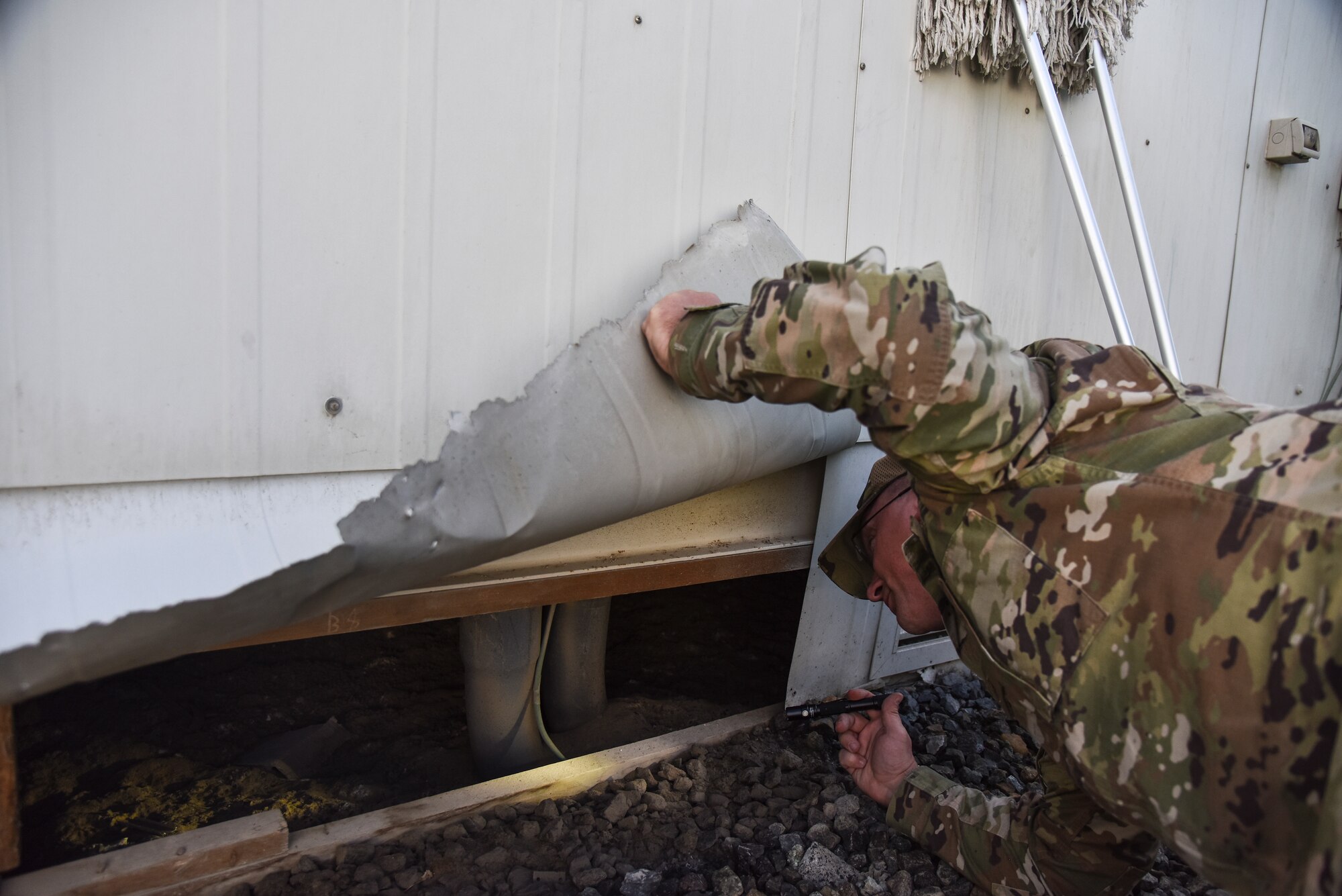 Master Sgt. Robert Rzasa, 380th Expeditionary Civil Engineer Squadron pest management superintendent, searches for stray cats at Al Dhafra Air Base, United Arab Emirates, Feb. 18, 2019. Pest management Airmen have multiple capabilities ranging from keeping bases free of pests that could carry debilitating infectious diseases to repelling birds from airfields to ensure safe takeoff and landings, protecting the health and safety of everyone on base. (U.S. Air Force photo by Senior Airman Mya M. Crosby)