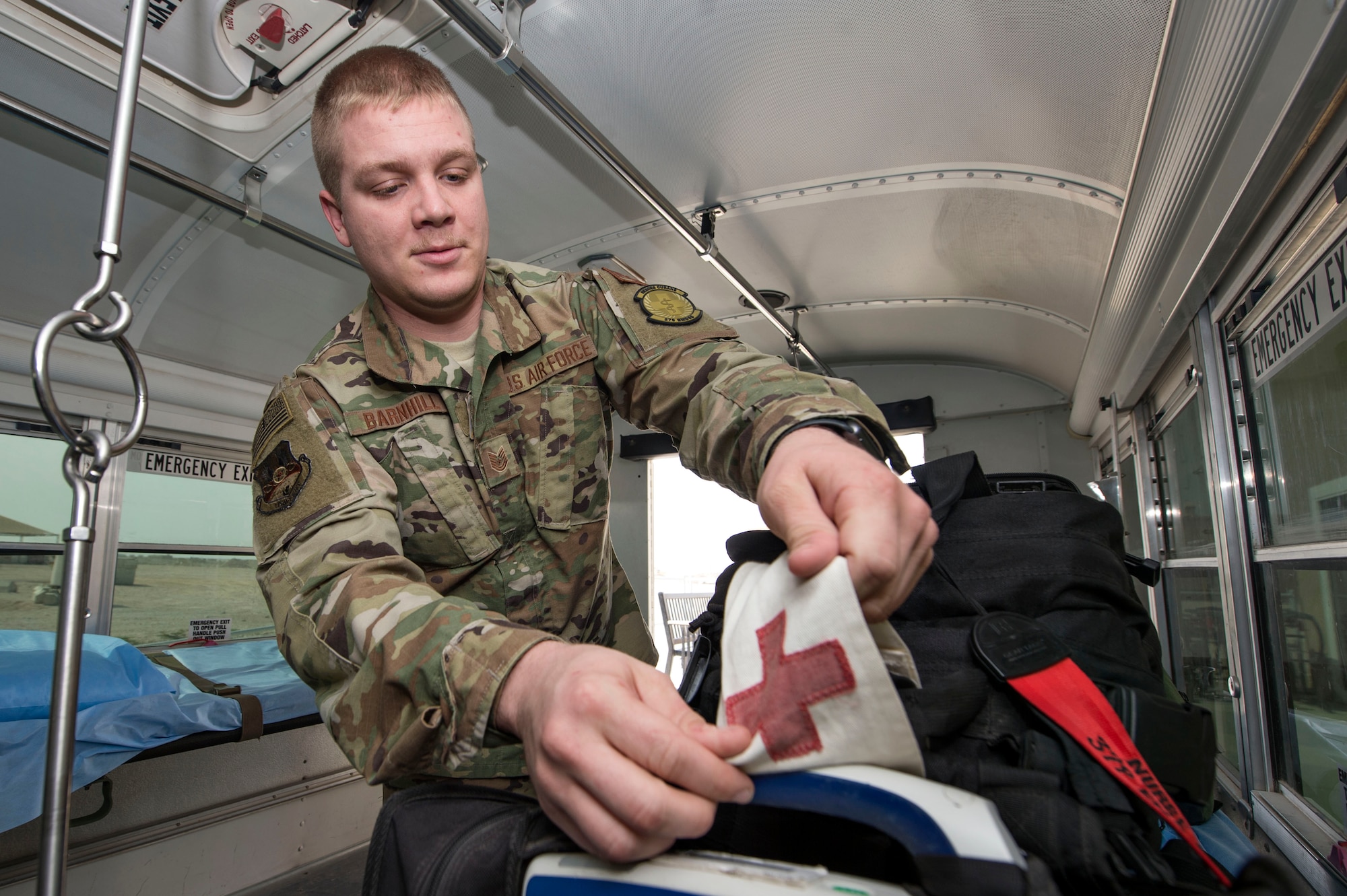 Tech. Sgt. Zachary Barnhill, 379th Expeditionary Medical Support Squadron (EMDSS) En Route Patient Staging (ERPS) Facility shift supervisor, prepares medical equipment on a bus prior to picking up patients on the flightline at Al Udeid Air Base, Qatar, Feb. 27, 2019. Airmen at the 379th EMDSS’s ERPS facility work at both the clinic and on the flightline to ensure safe transport and care is provided to in-transit patients during their stay at Al Udeid before they are moved to locations supporting higher levels of medical treatment, if necessary. (U.S. Air Force photo by Tech. Sgt. Christopher Hubenthal)