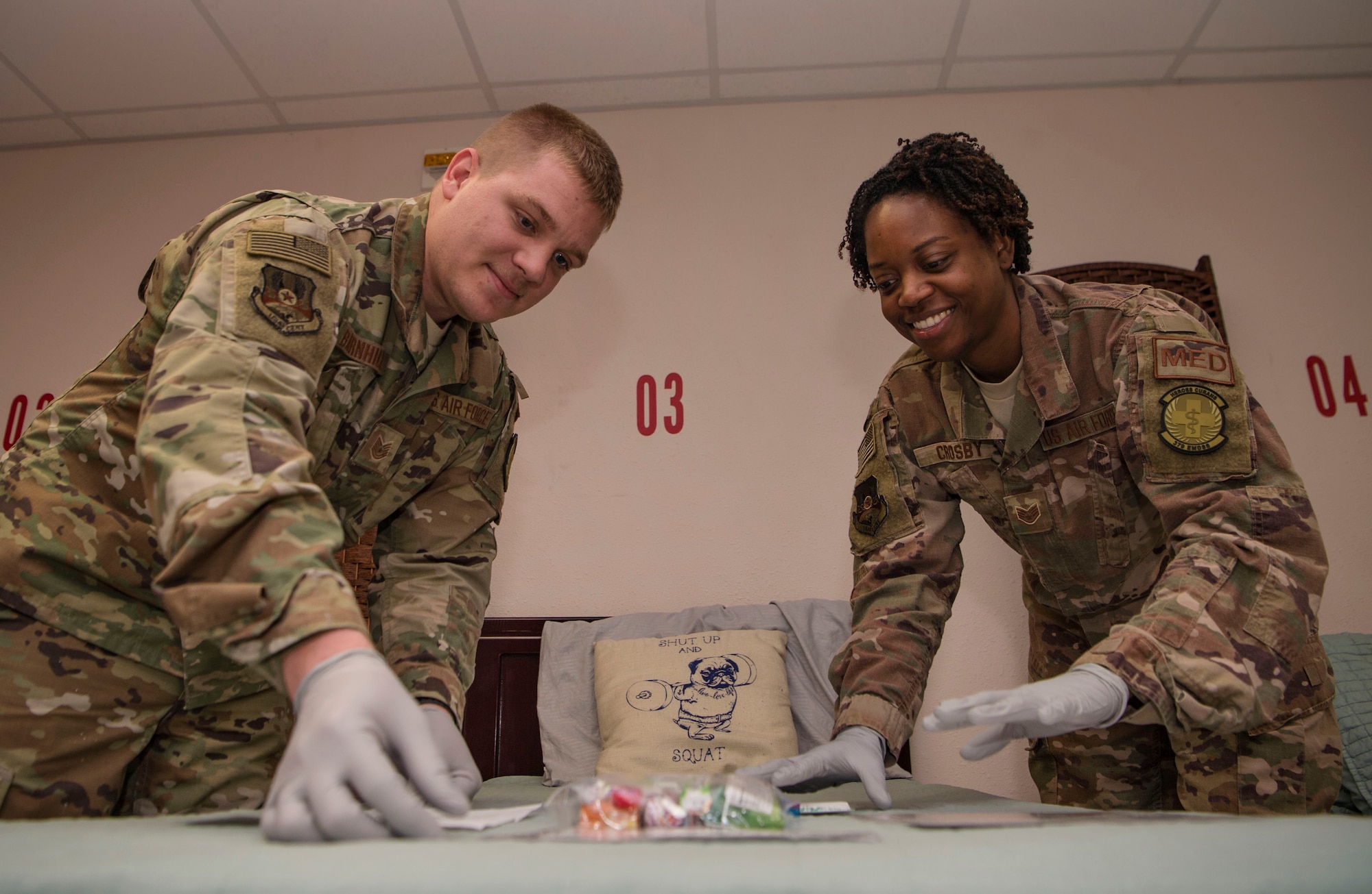 Tech. Sgt. Zachary Barnhill, left, 379th Expeditionary Medical Support Squadron (EMDSS) En Route Patient Staging (ERPS) Facility shift supervisor, and Staff Sgt. Erica Crosby, 379th EMDSS ERPS medical technician, set up an inbound patient bed Feb. 27, 2019, at Al Udeid Air Base, Qatar. Airmen at the 379th EMDSS’s ERPS facility work at both the clinic and on the flightline to ensure safe transport and care is provided to in-transit patients during their stay at Al Udeid before they are moved to locations supporting higher levels of medical treatment, if necessary. (U.S. Air Force photo by Tech. Sgt. Christopher Hubenthal)