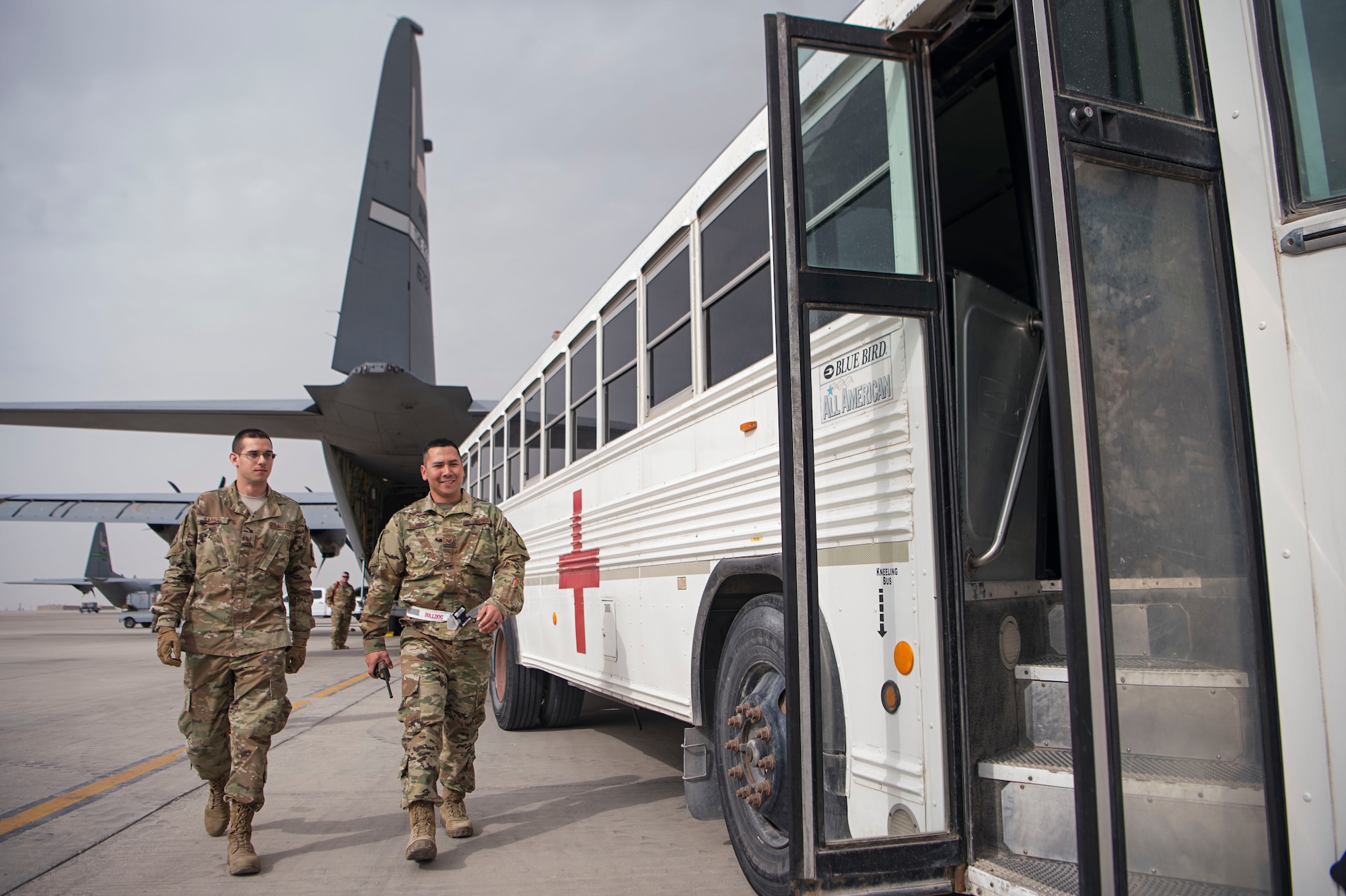 Tech. Sgt. Clauber Santos, left, 379th Expeditionary Medical Support Squadron (EMDSS) En Route Patient Staging (ERPS) Intra-Theater Care Program NCO in charge, and Staff Sgt. Daniel Sarsona, 379th EMDSS ERPS referral management NCO in charge, make their way onto a medical bus after loading in-transit patients and their luggage Feb. 27, 2019, at Al Udeid Air Base, Qatar. Airmen at the 379th EMDSS’s ERPS facility work at both the clinic and on the flightline to ensure safe transport and care is provided to in-transit patients during their stay at Al Udeid before they are moved to locations supporting higher levels of medical treatment, if necessary. (U.S. Air Force photo by Tech. Sgt. Christopher Hubenthal)