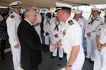 SUNDA STRAIT (March 1, 2019) U.S. Ambassador to Indonesia Joseph Donovan Jr. greets Lt. Cmdr. Joshua Cowart, executive officer of the Avenger-class mine countermeasures ship USS Chief (MCM 14) prior to a memorial service aboard the Indonesian Navy (TNI-AL) ship Kri Usman Harun (359). The ceremony was held to honor the American and Australian crews of USS Houston (CA 30) and HMAS Perth (D 29) that lost their lives in battle against the Japanese Imperial Navy during World War II.