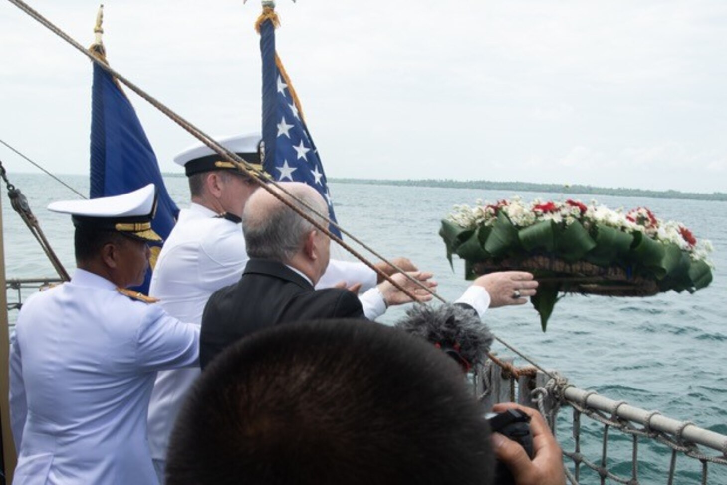 SUNDA STRAIT (March 1, 2019) U.S. Ambassador to Indonesia Joseph Donovan Jr. (right), Cmdr. Greg Adams (center), Naval Atache of U.S. Embassy Jakarta, and a senior leader of the Indonesian Navy (TNI-AL) lay a wreath during a memorial service aboard the Indonesian Navy ship Kri Usman Harun (359). The ceremony was held to honor the American and Australian crews of USS Houston (CA 30) and HMAS Perth (D 29) that lost their lives in battle against the Japanese Imperial Navy during World War II.