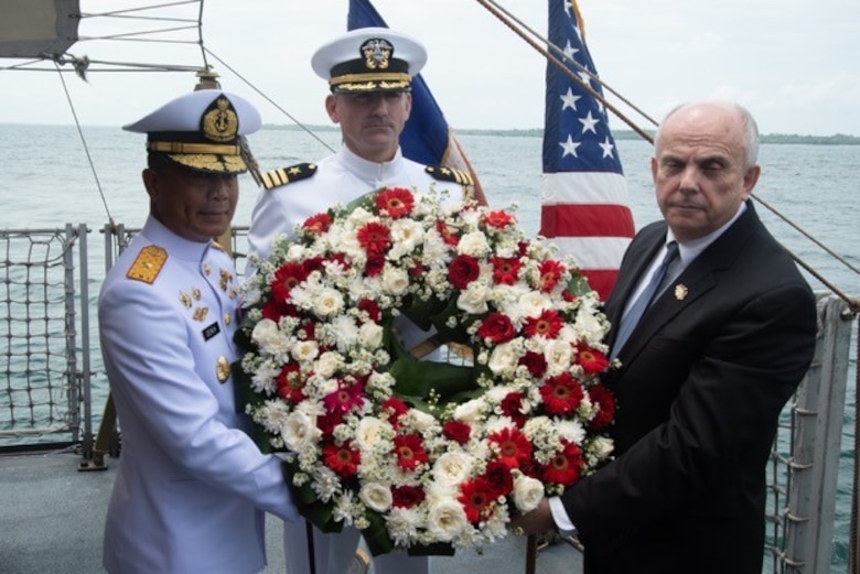 U.S. Ambassador to Indonesia Joseph Donovan Jr. (right), Cmdr. Greg Adams (center), Naval Attaché of U.S. Embassy Jakarta, and a senior leader of the Indonesian Navy (TNI-AL) prepare to lay a wreath during a memorial service aboard the Indonesian Navy ship Kri Usman Harun (359). The ceremony was held to honor the American and Australian crews of USS Houston (CA 30) and HMAS Perth (D 29) that lost their lives in battle against the Japanese Imperial Navy during World War II.