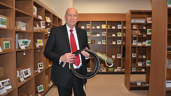 Steven Kelly, a special projects officer for the Replenishment Parts Purchase or Borrow Program at DLA Aviation, holds an electrical cable assembly, one of almost 200 items prospective vendors can replicate using already existing technical data or reverse engineering in hopes of becoming an approved source.