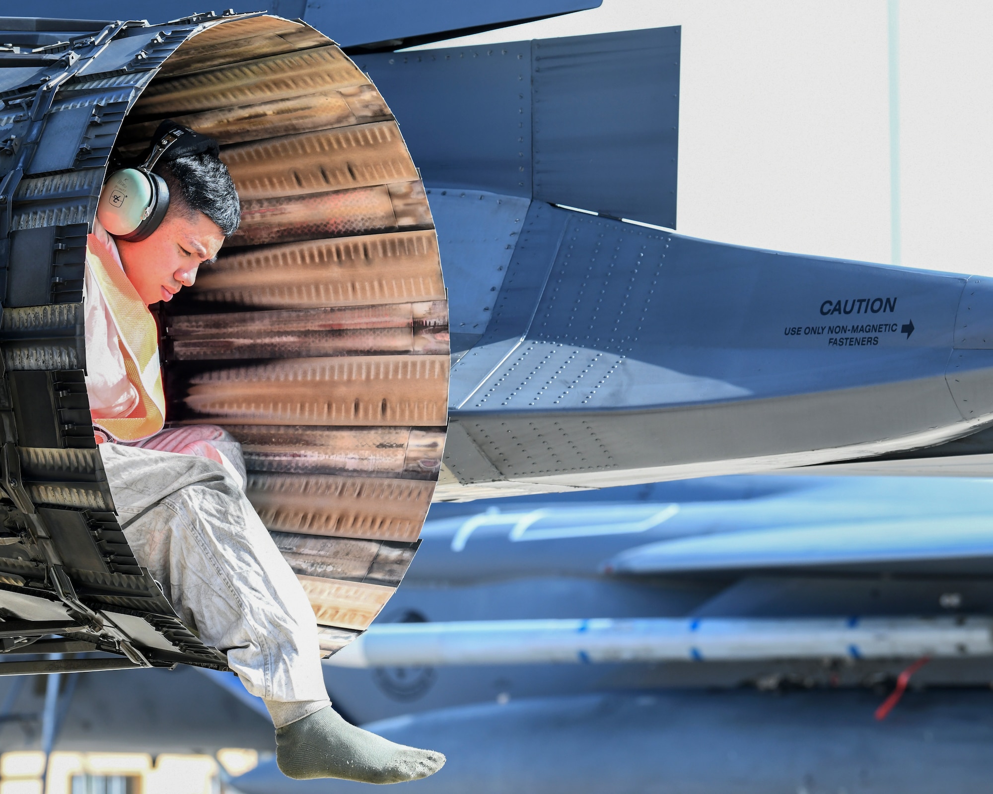 An engine of an F-15E Strike Eagle with an Airman seated inside