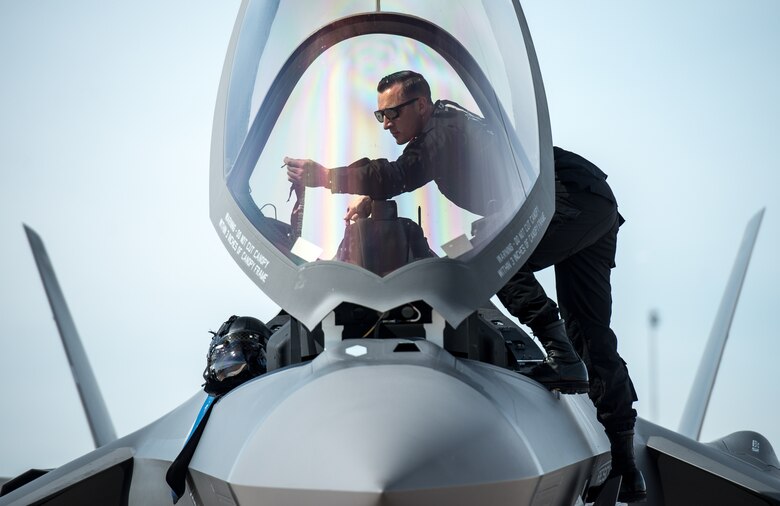 A crew chief, prepares to close the canopy on an F-35A