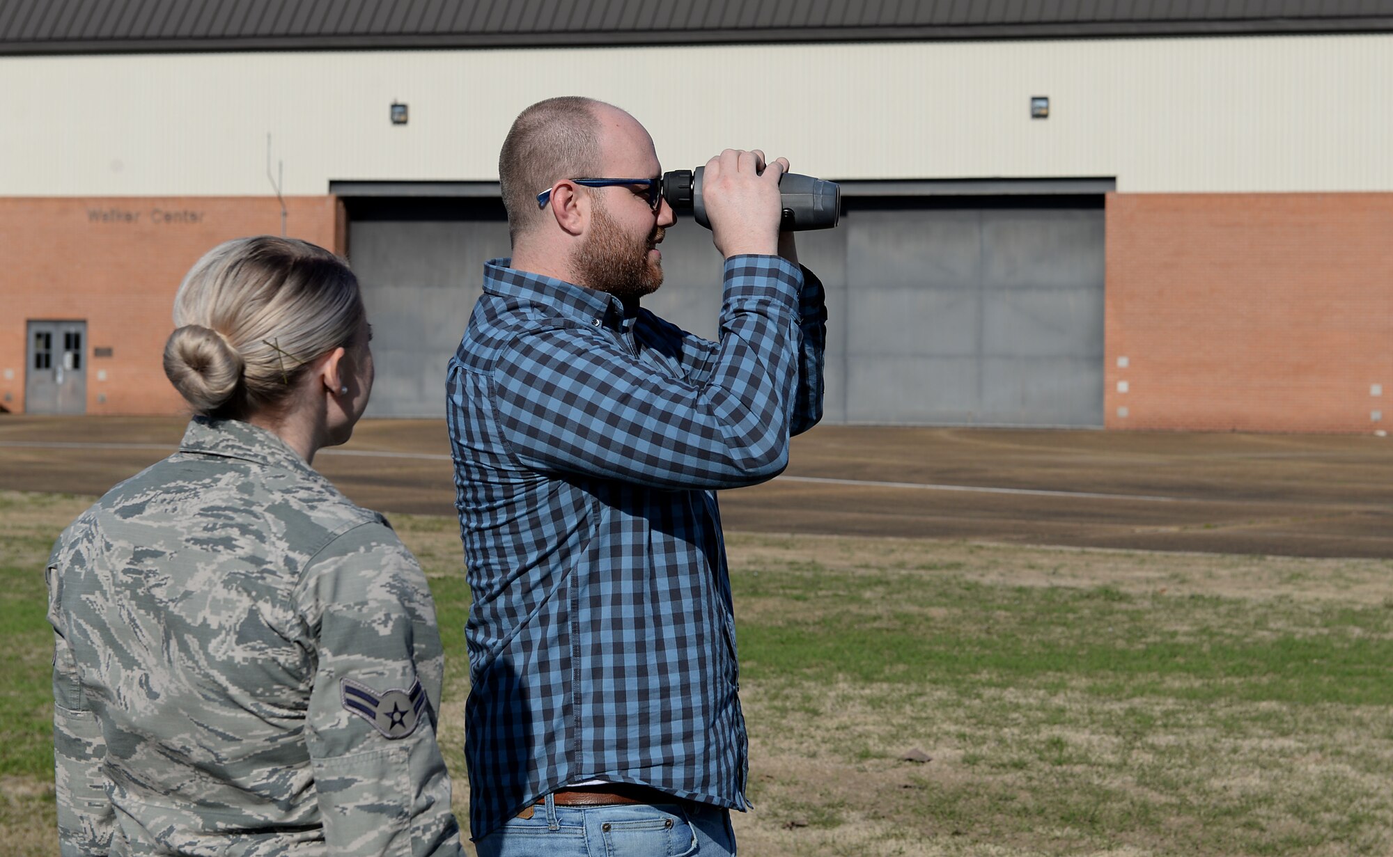 Steven Vasko, 14th Operations Support Squadron Weather Flight meteorological technician, demonstrates to Airman 1st Class Lauren Rodgers, 14th OSS Weather Flight apprentice, how to use a laser range finder Feb. 27, 2019, on Columbus Air Force Base, Mississippi. Weather is an unpredictable force of nature, however, with accurate critical weather analysis, these Airmen are able to aid in creating pilots and protecting Team BLAZE. (U.S. Air Force photo by Airman Hannah Bean)