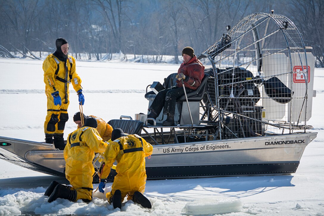 men in airboat on ice train to rescue a victim who had fallen through