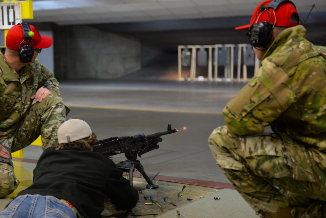 Justin Mohler, a teenager with Make-A-Wish South Dakota, fires an M-240B light machine gun at the 28th Security Forces Squadron Combat Arms Training and Maintenance indoor firing range under the watchful eye of two instructors during a base tour at Ellsworth Air Force Base, S.D., Feb. 26, 2019. Mohler was notified that his dream to visit the Sept. 11 memorial in New York City was granted at the finale of the base visit. (U.S. Air Force photo by Senior Airman Nicolas Z. Erwin)