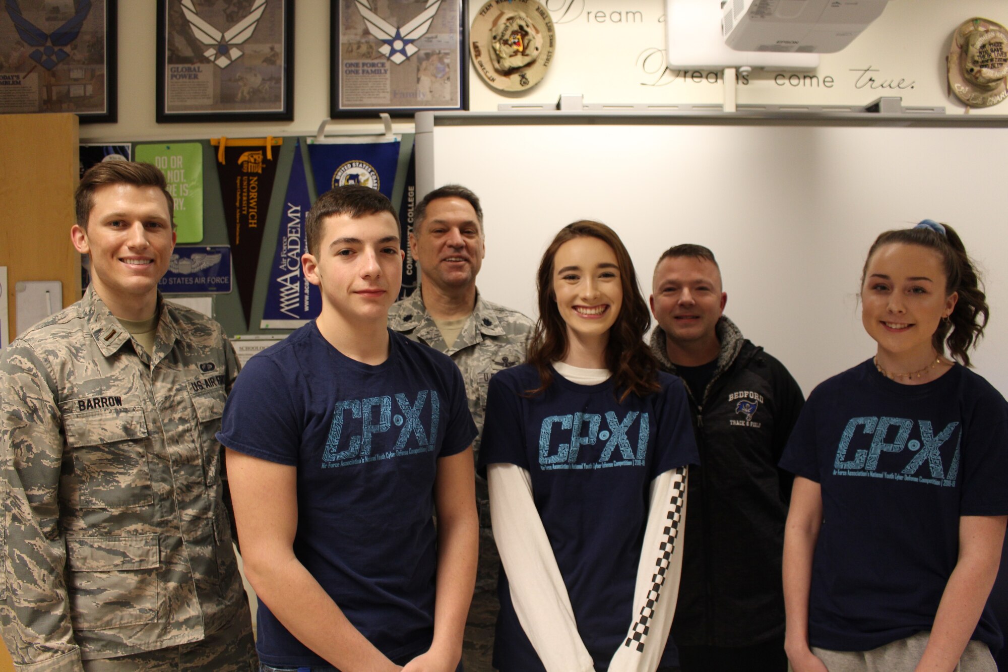 Hanscom Air Force Base mentors 2nd Lt. Gregory Barrow, and retired Lt. Col. Ken Mierz, and retired Master Sgt. Charlie Humphrey pose with CyberPatriot competitors Cadet Col. Cameron Edens, left, Cadet Col. Mak Marrs, center, and Cadet Staff Sgt. Avree Dillingham, from Bedford High School, Bedford, Mass., Feb. 25. CyberPatriot is an Air Force Association-sponsored program designed to train middle- and high-school students in network operations and security. This was the first year Hanscom mentored teams. (U.S. Air Force photo courtesy of 2nd Lt. Gregory Barrow)
