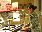An airman builds her meal using fresh, health options on the Pure Bar at the Aragon Dining Facility on Peterson Air Force Base, Colorado, Feb. 28, 2019. Pure Bars, packed with whole grains, fresh fruits and other nutritional offerings, are part of the Air Force's Go For Green program designed to provide healthy, power fueling for Airmen.