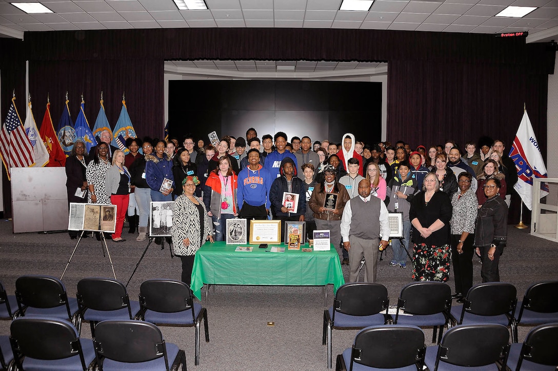 Battle Creek Central High School students pose with educator Gigi Coleman during a Black History Month program at the Hart-Dole-Inouye Federal Center in Battle Creek, Michigan, Feb. 28.