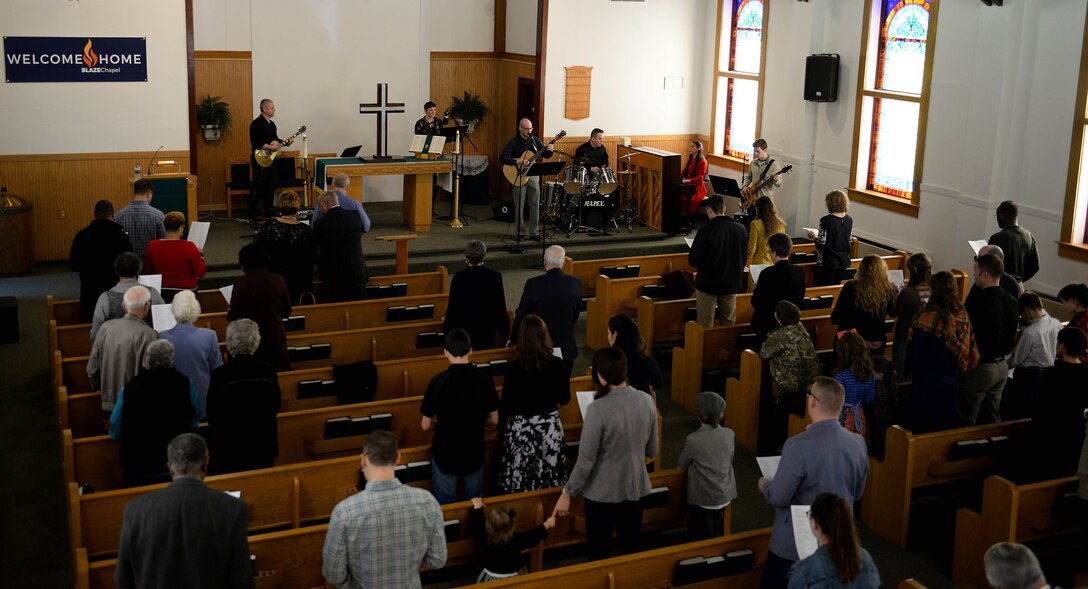 Attendees sing with the band during service at the BLAZE Chapel Feb. 24, 2019, on Columbus Air Force Base, Mississippi. During the service Chaplain (Col.) Doug Slater, Air Education and Training Command chaplain, from Joint Base San Antonio-Randolph, Texas, delivered his final sermon of his Air Force career. (U.S. Air Force photo by Airman Hannah Bean)