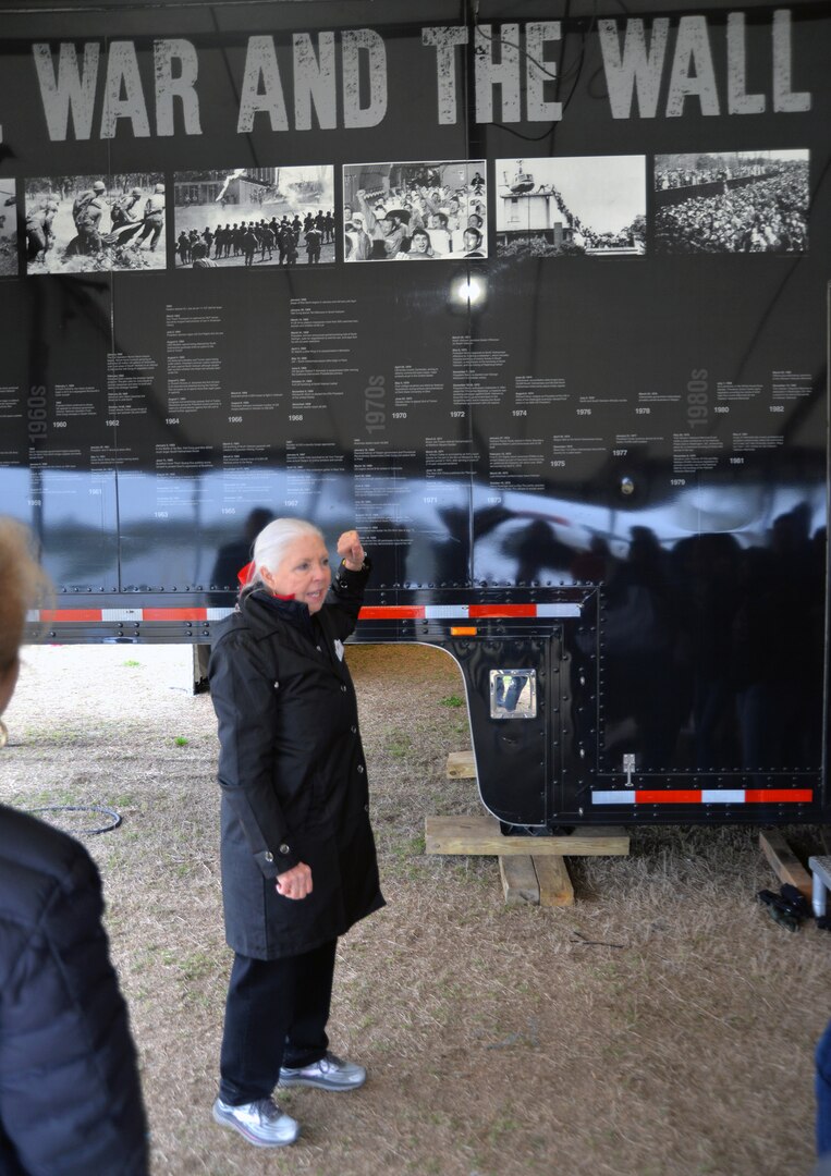 Joyce Turnipseede, a member of the Daughters of the American Revolution’s Alamo Chapter, speaks to visitors about “The Wall That Heals,” a traveling representation of the Vietnam Veterans Memorial, at the cemetery Feb. 28 through March 3.