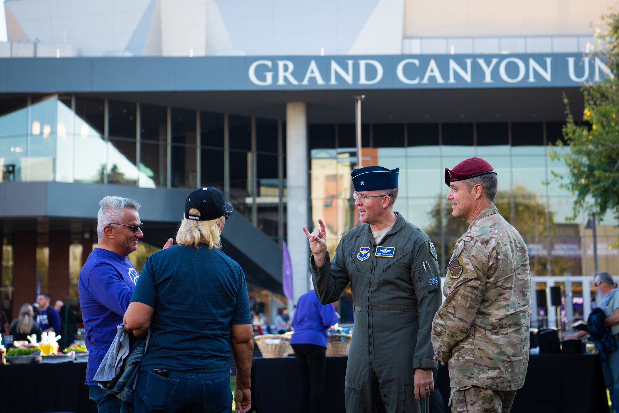 Brig. Gen. Todd Canterbury, 56th Fighter Wing commander and Chief Master Sgt. Ronald Thompson, 56th FW command chief, speak with Grand Canyon University Alumni at a tailgate, Feb. 27, 2019 in Phoenix, Ariz.