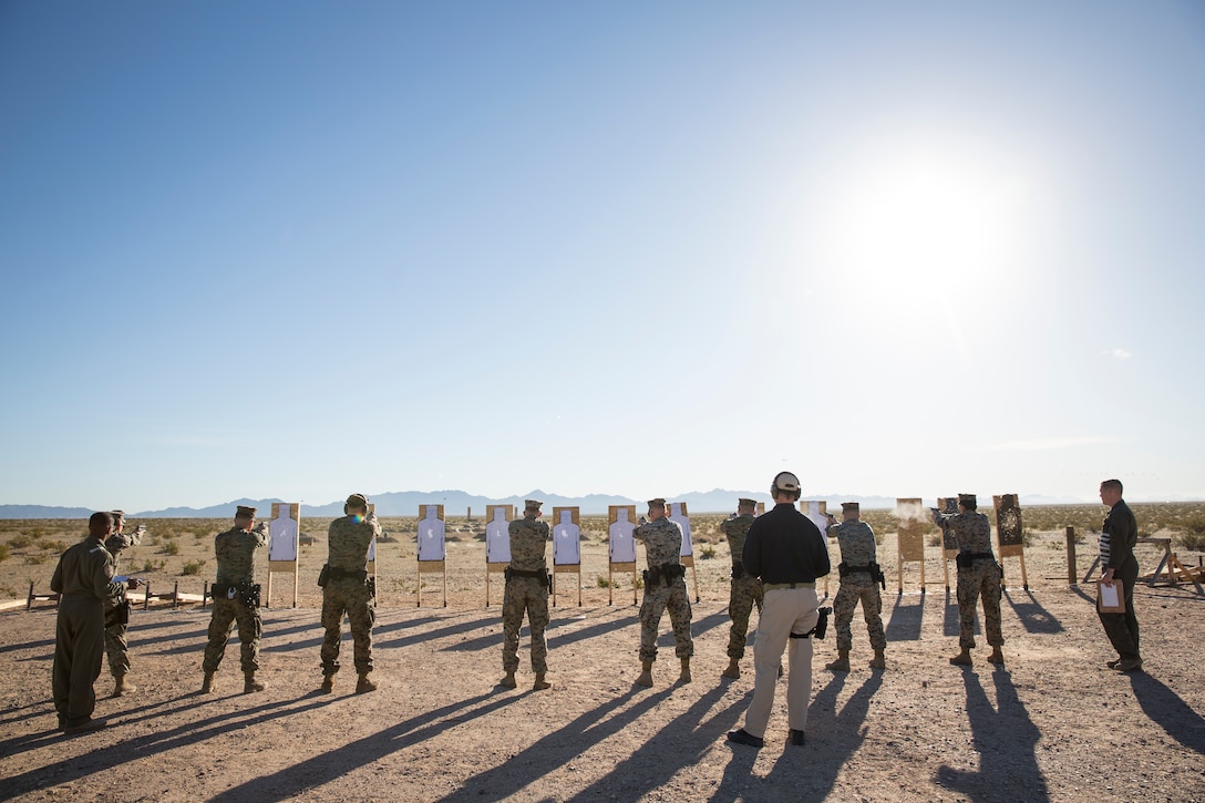 U.S. Marines with the Provost Marshal's Office (PMO), Headquarters and Headquarters Squadron (H&HS), Marine Corps Air Station (MCAS) Yuma, engage targets during a law enforcement (LE) range qualification on MCAS Yuma Ariz., Feb. 28, 2019. The LE qualification is specific to military police personnel, including several different shooting methods with both the Beretta M9 pistol and Benelli 12 gauage shotgun. (U.S. Marine Corps photo by Sgt. Allison Lotz)