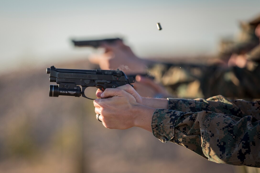 U.S. Marines with the Provost Marshal's Office (PMO), Headquarters and Headquarters Squadron (H&HS), Marine Corps Air Station (MCAS) Yuma, engage targets during a law enforcement (LE) range qualification on MCAS Yuma Ariz., Feb. 28, 2019. The LE qualification is specific to military police personnel, including several different shooting methods with both the Beretta M9 pistol and Benelli 12 gauage shotgun. (U.S. Marine Corps photo by Sgt. Allison Lotz)