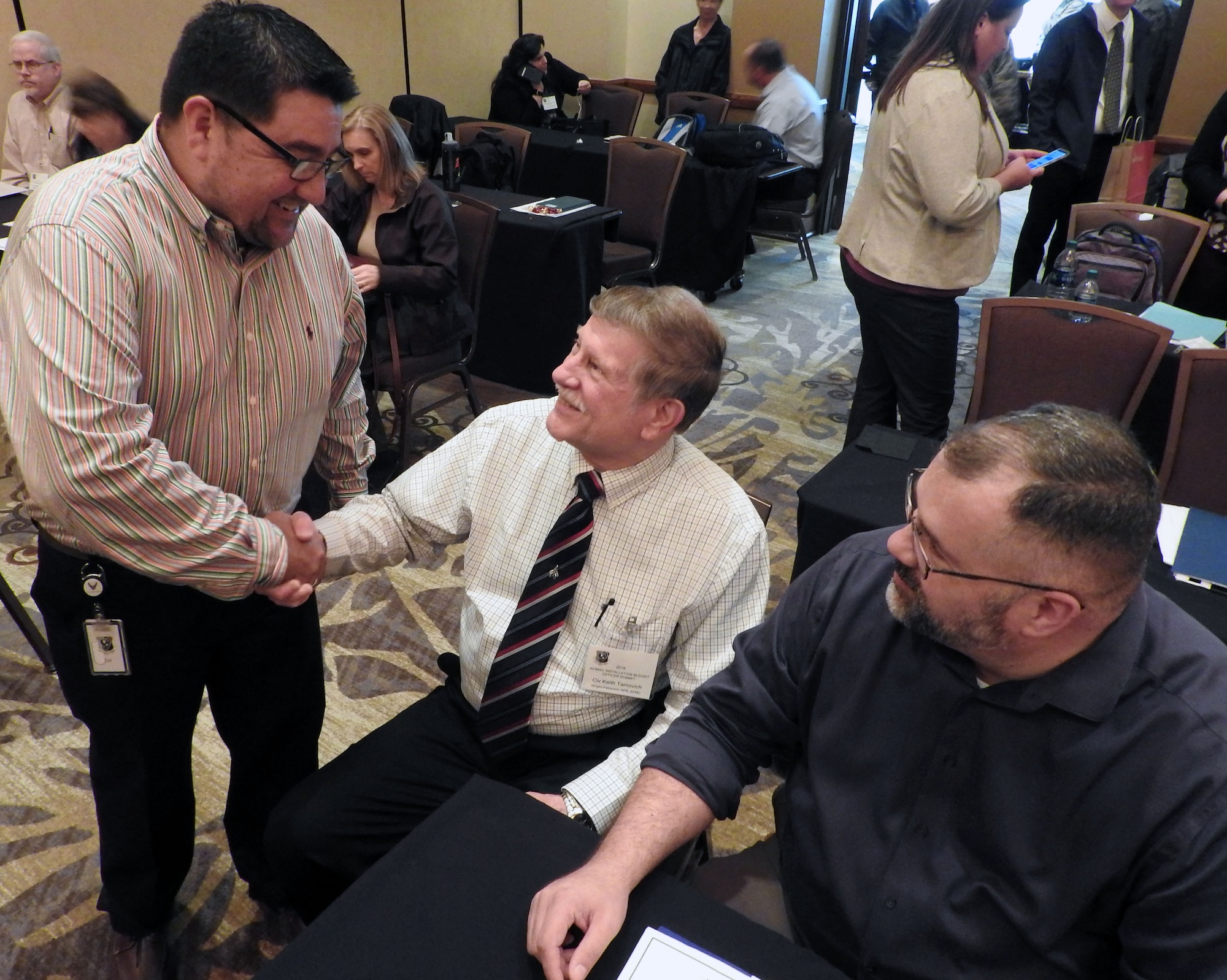 Felix Saenz, AFIMSC budget analyst for Air Force Materiel Command, left, meets Keith Tarnovich, Mission Support Group team chief, Wright-Patterson Air Force Base, Ohio, and Keith Westerbeck, Financial Management Analysis Office chief, Tinker Air Force Base, Oklahoma, during the Air Force Budget Officers Summit in San Antonio, Feb. 28.