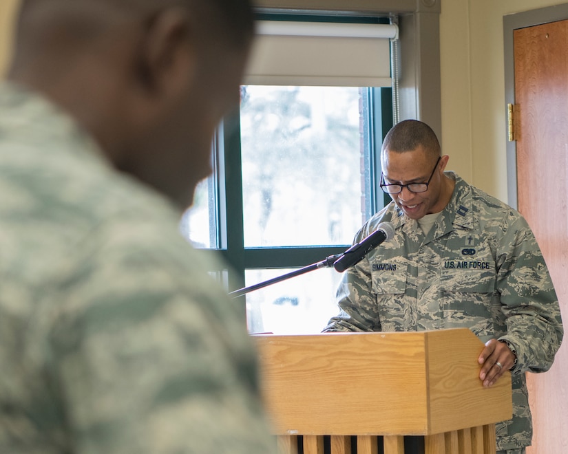 Col. Terrence Adams, 628th Air Base Wing commander, foreground, bows his head as Capt. Thomas Simmons, 628th Air Base Wing chaplain, recites the invocation for the 2019 National African American Black History Program Celebration Feb 27, 2019, at Joint Base Charleston’s Chapel Annex in Charleston, S.C.