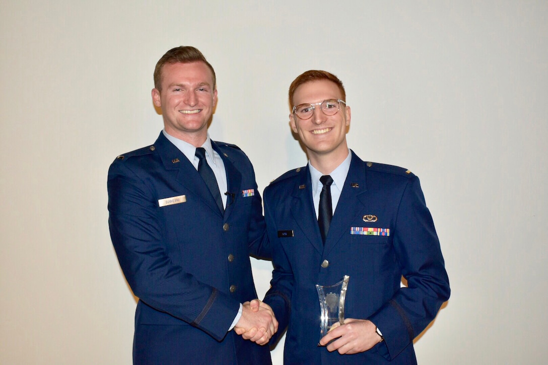 From left, 1st Lt. Tim Sobieski of the 627th Air Base Group and 2nd Lt Alexander Bow, 627th Civil Engineer Squadron, both at JB-Lewis-McChord, Washington, pose with their trophy after winning second place in the first AFIMSC Innovation Rodeo. During the event, the lieutenants pitched an idea by Bow and Capt. Gregory Hege, currently deployed to Air Force Central Command, Al Udeid, Qatar. The idea is to leverage existing Geospatial Information System AI learning for Facility Roof Inspections. The team finished second in the event. (U.S. Air Force photo by Armando Perez)