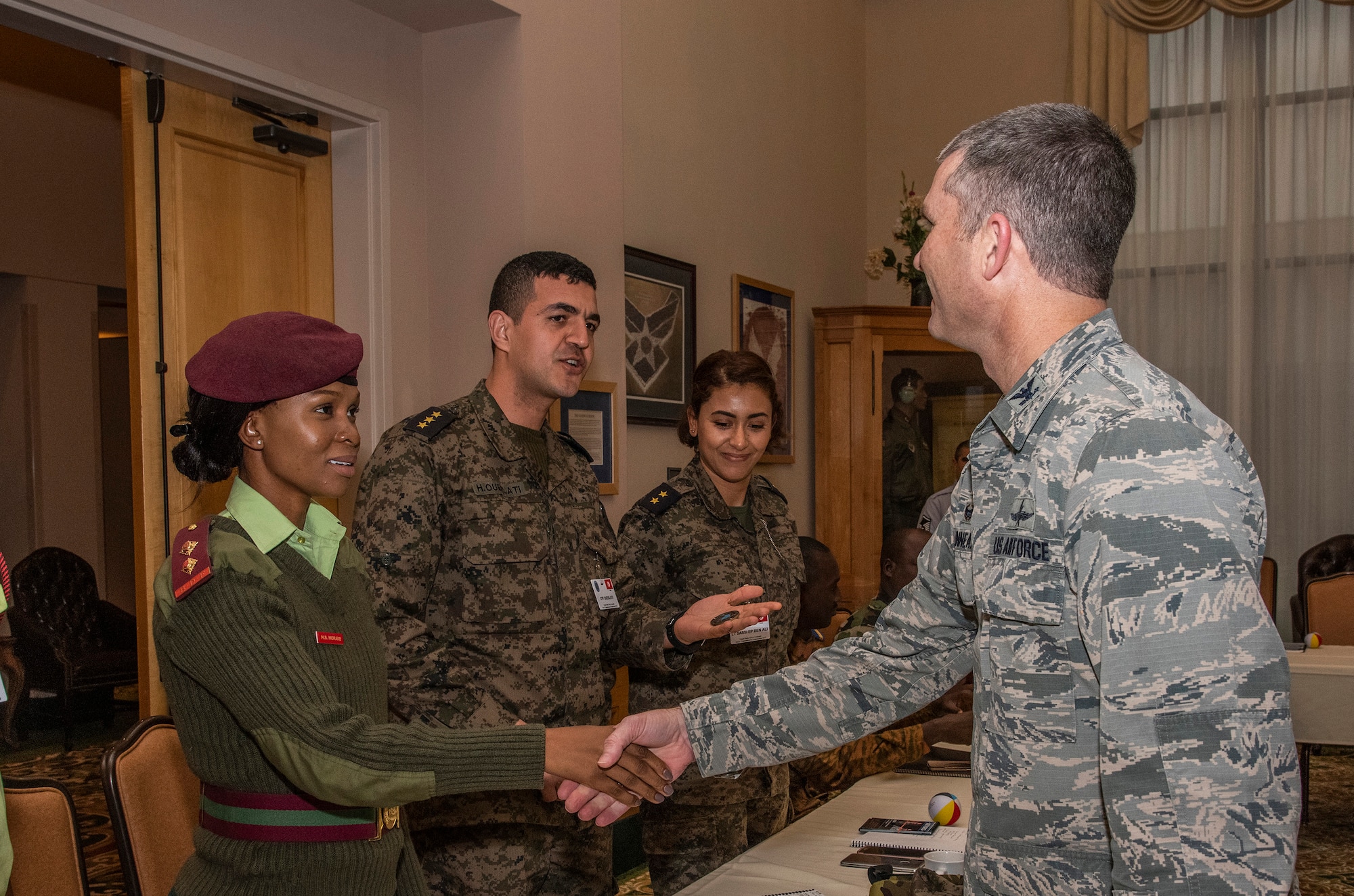 Botswana Defense Force Lt. Matshidiso Morake receives a coin from Col. Harold Linnean, 960th Cyberspace Wing vice commander duing a visit to Joint Base San Antonio-Lackland, Texas, Feb. 28.